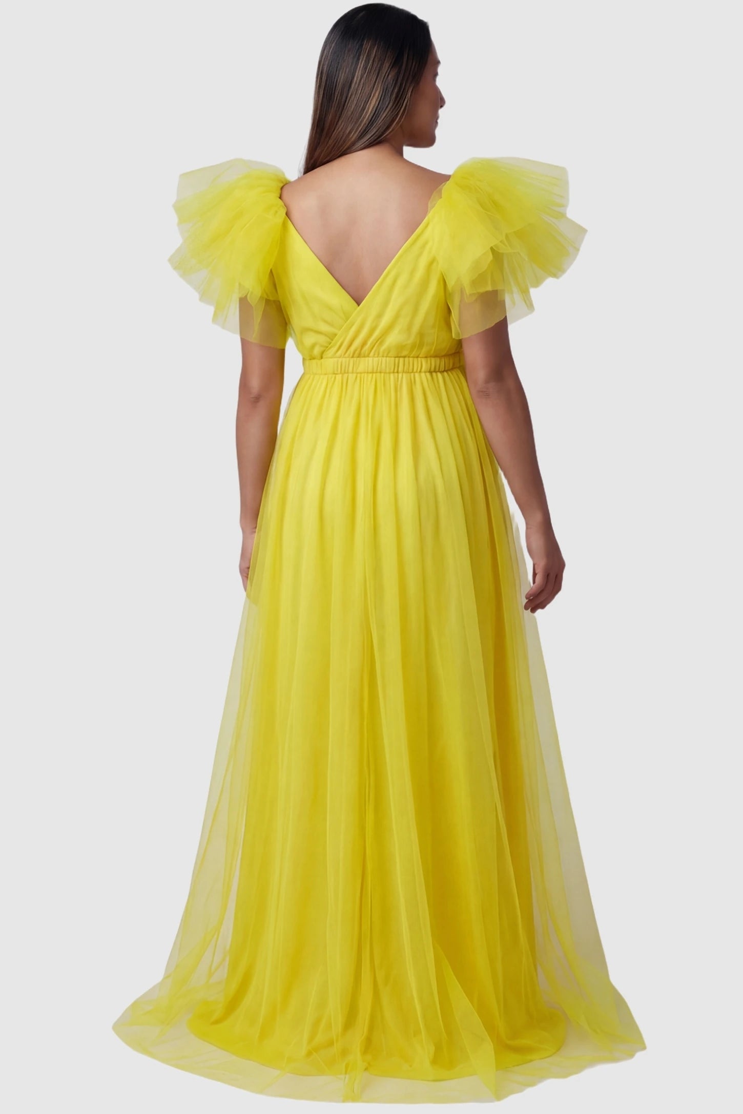 Layered Tulle Ruffle Sleeve Maternity Photoshoot Dress Layered Tulle Ruffle Sleeve Maternity Photoshoot Dress in Lemon Yellow featuring a V-back on a pregnant model.