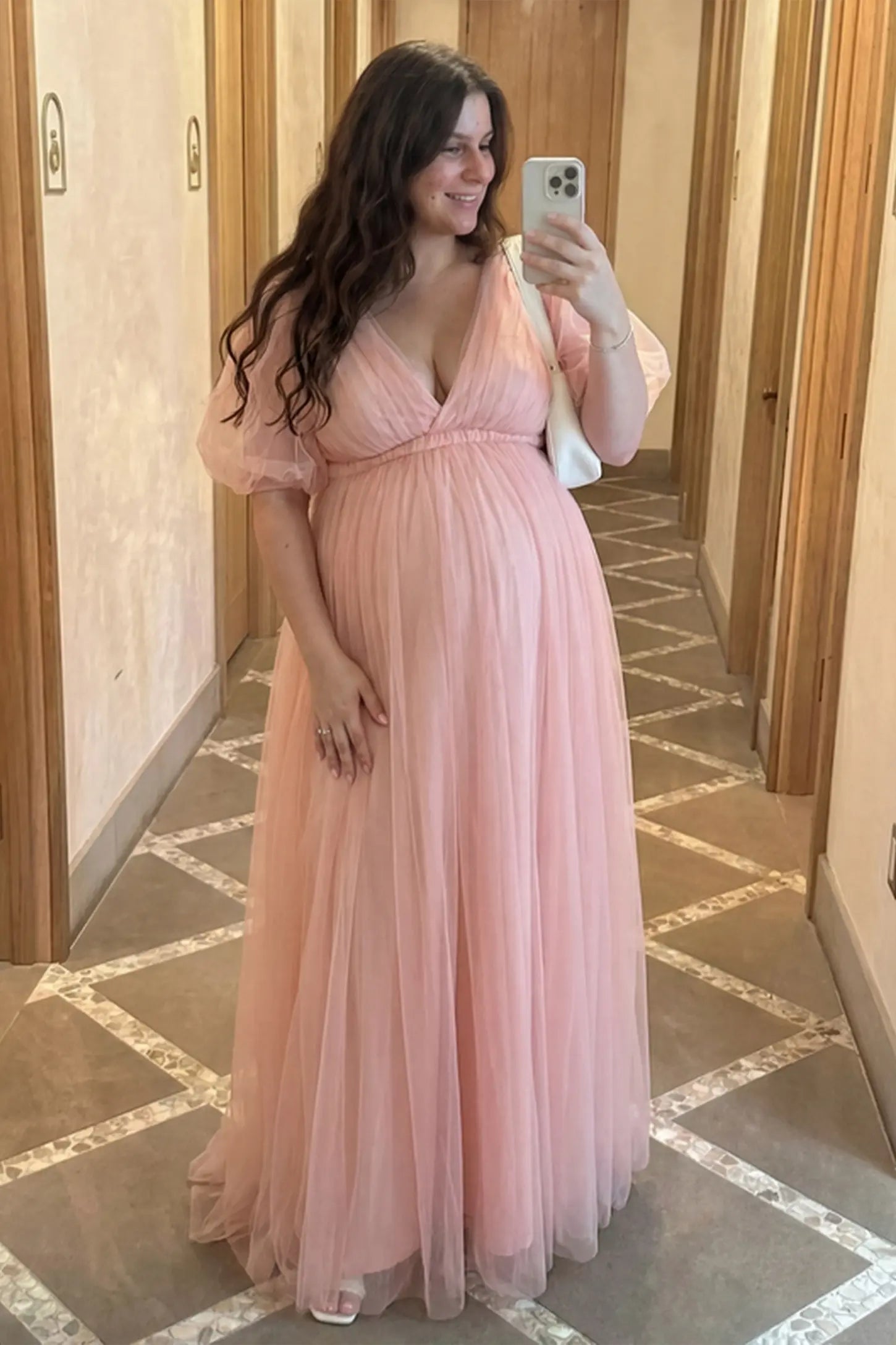 Layered Tulle Ruffle Sleeve Maternity Photoshoot Dress Layered Tulle Ruffle Sleeve Maternity Photoshoot Dress in Pink featuring an empire waist on a pregnant model.
