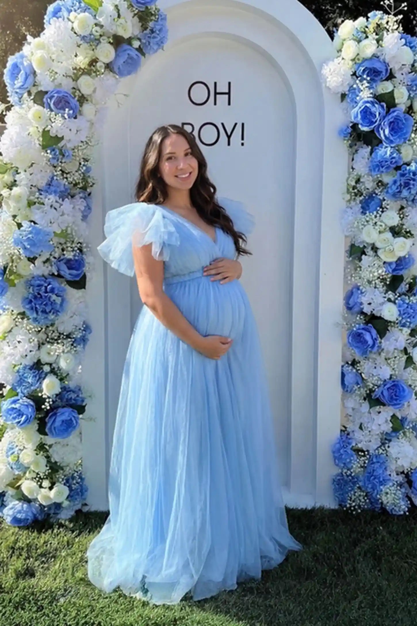 Layered Tulle Ruffle Sleeve Maternity Photoshoot Dress in Sky Blue featuring a plunging neckline on a pregnant model.