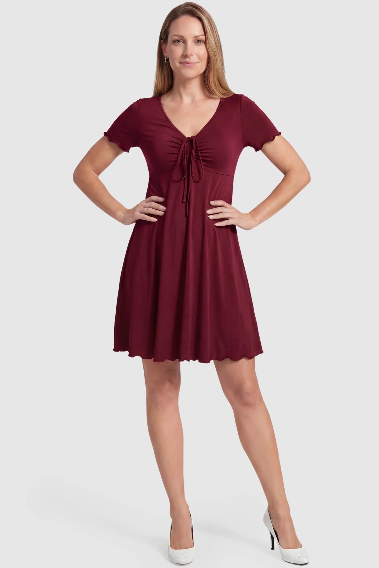 Lettuce Trim A-Line Mini Maternity Dress Lettuce Trim A-Line Mini Maternity Dress in Burgundy featuring a V-neckline on a non-pregnant postpartum model.