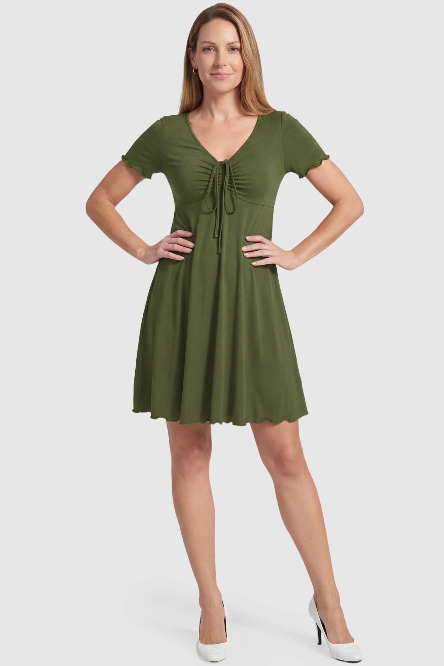 Lettuce Trim A-Line Mini Maternity Dress Lettuce Trim A-Line Mini Maternity Dress in Green featuring a V-neckline on a non-pregnant postpartum model.