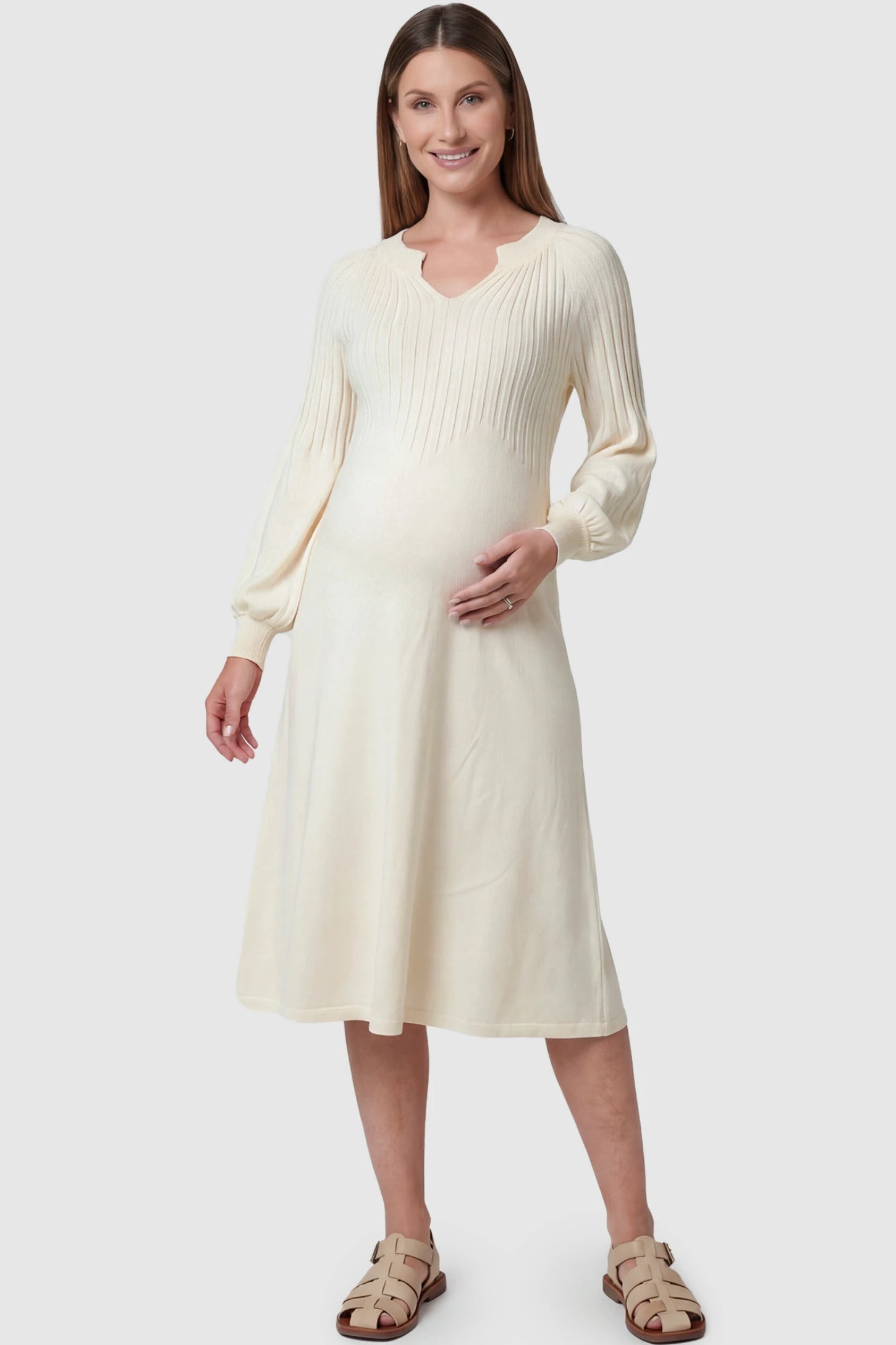 Notched Neck Long Sleeve Maternity Midi Dress Sweetheart neck long sleeve maternity midi dress in apricot with elegant long sleeves, front view on pregnant model