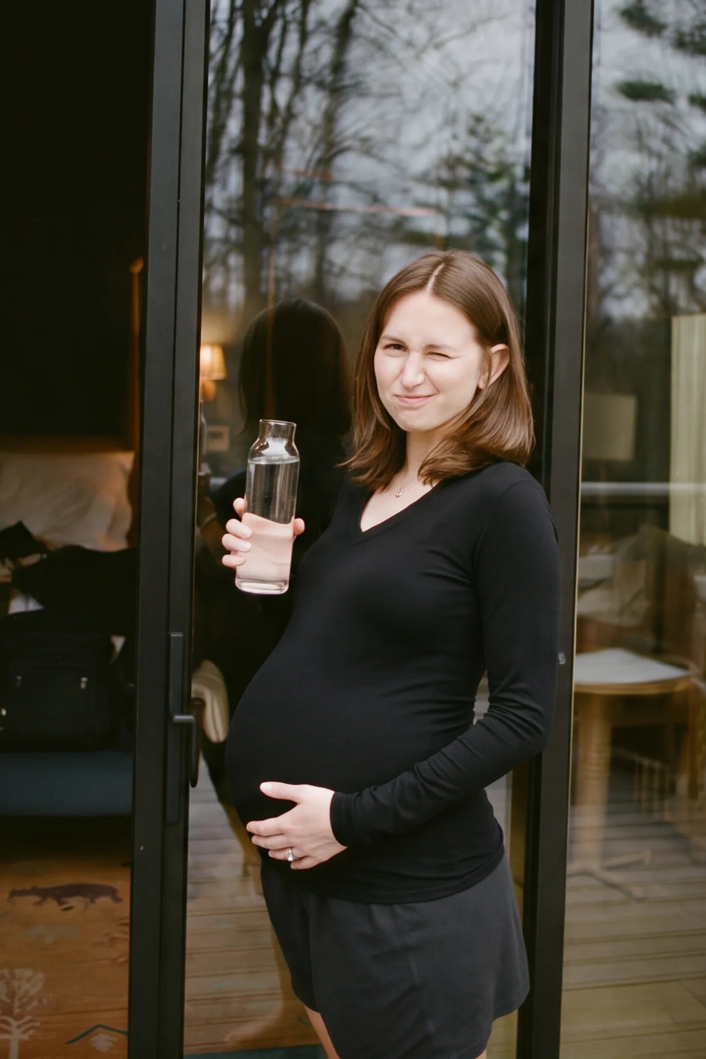 Soft Knit Long Sleeve V-Neck Maternity Top Soft knit long sleeve V-neck maternity top in black with flattering V-neckline and long sleeves, side view on pregnant model
