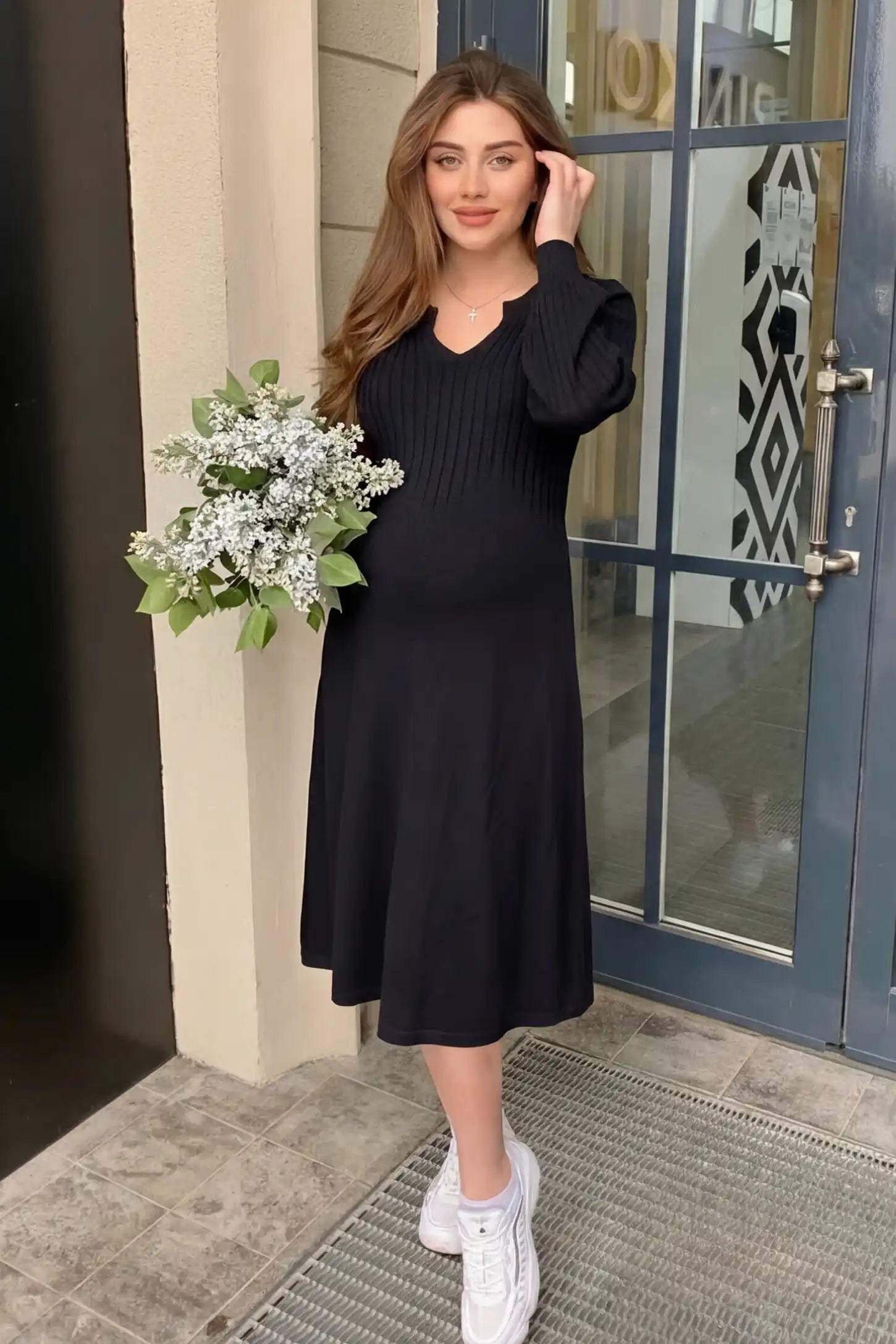 Sweetheart neck long sleeve maternity midi dress in black with elegant long sleeves, front view on pregnant model