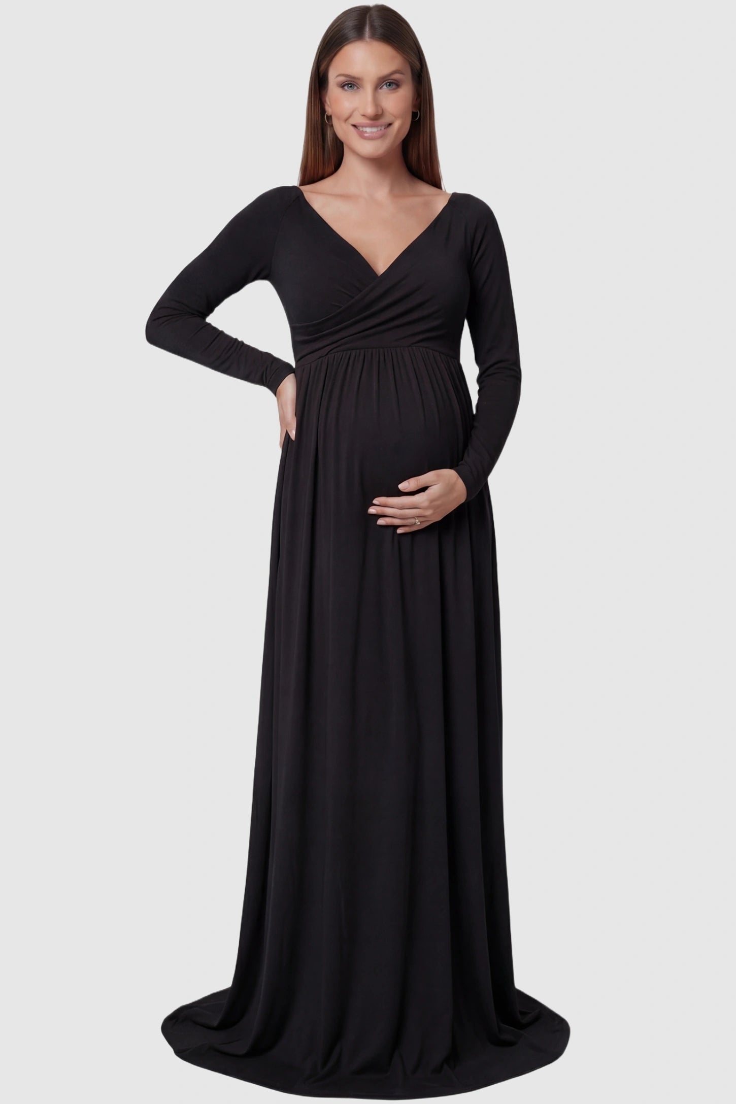 Off-Shoulder Long Sleeve Trailing Maxi Maternity Dress Off-shoulder long sleeve trailing maxi maternity dress in black featuring an elegant long sleeve silhouette in front view on a pregnant model