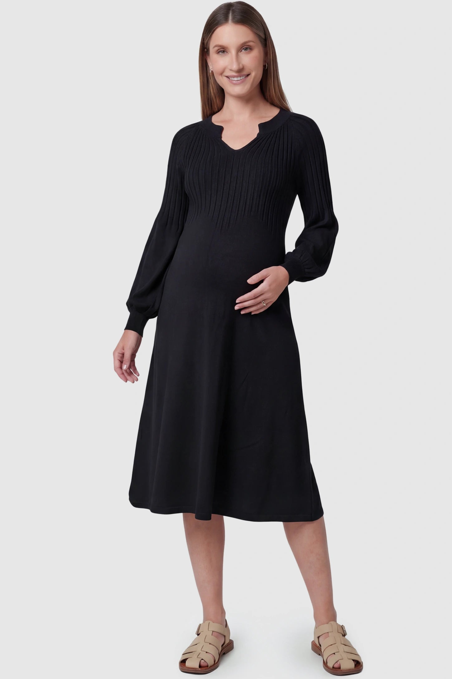 Sweetheart neck long sleeve maternity midi dress in black with elegant long sleeves, front view on pregnant model