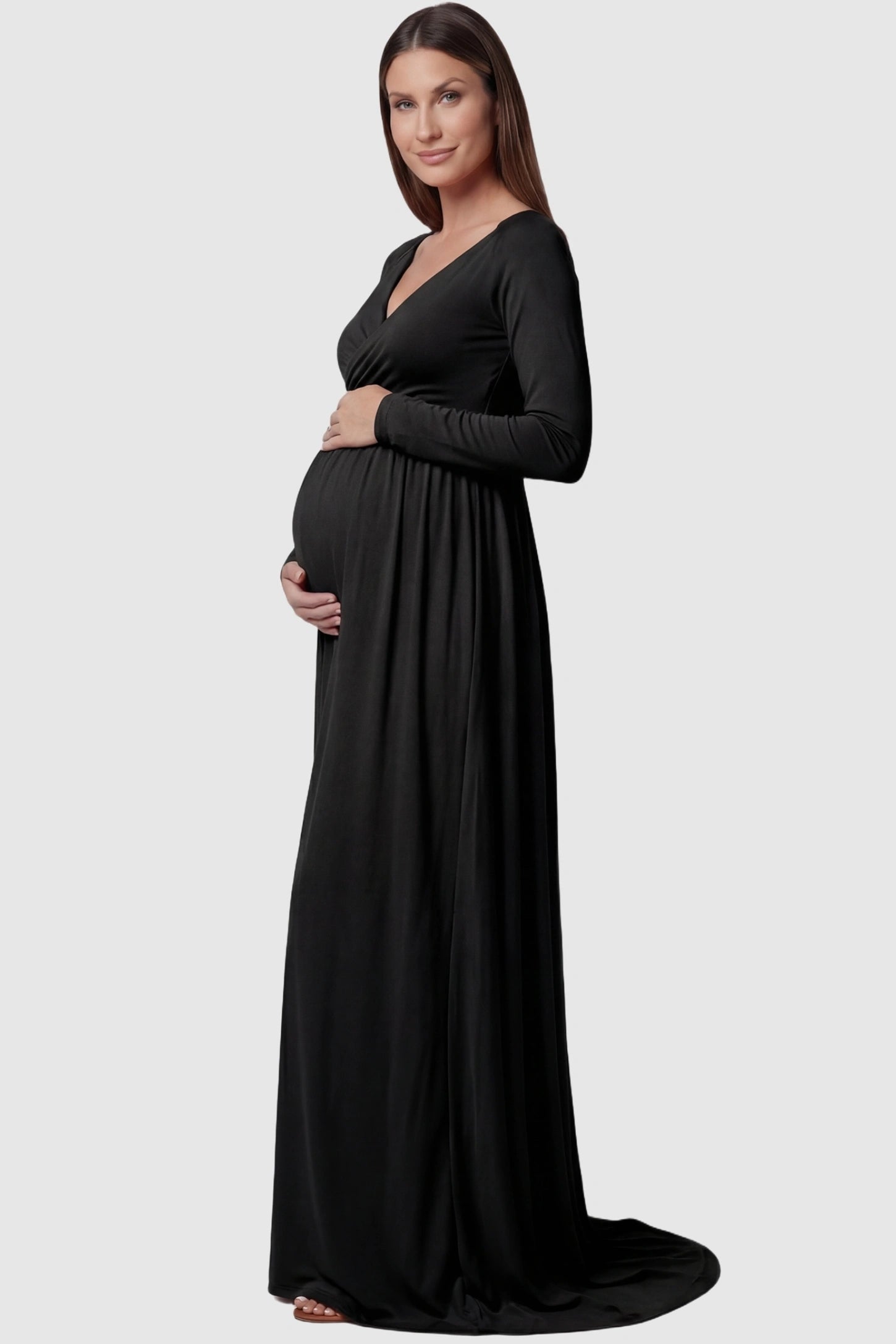 Off-Shoulder Long Sleeve Trailing Maxi Maternity Dress Off-shoulder long sleeve trailing maxi maternity dress in black featuring elegant long sleeve silhouette in side view on a pregnant model