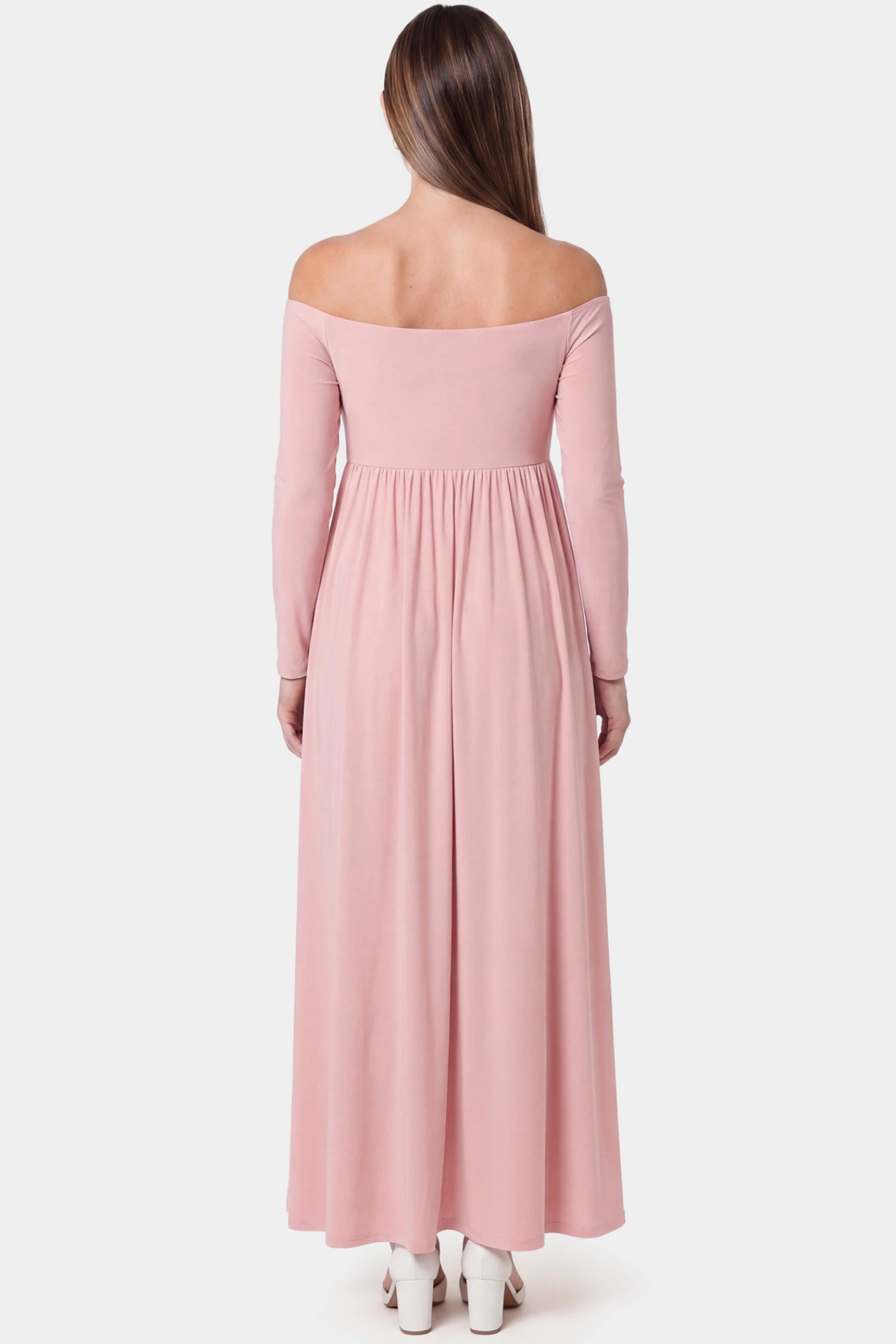 Off-Shoulder Long Sleeve Full Skirt Maxi Maternity Dress Off-shoulder long sleeve full skirt maxi maternity dress in pink featuring full flowing skirt in back view on a pregnant model