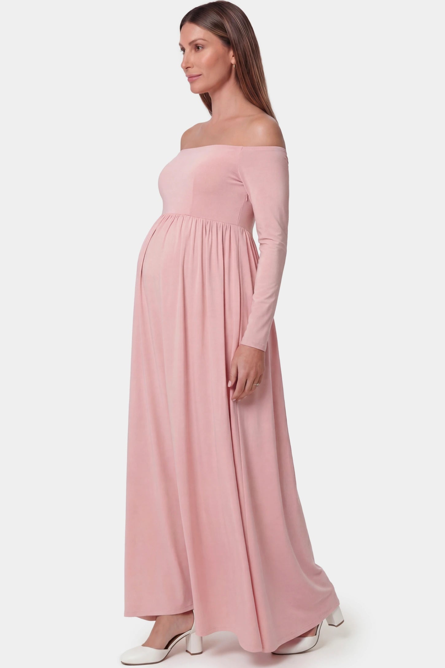 Off-shoulder long sleeve full skirt maxi maternity dress in pink featuring elegant long sleeves in side view on a pregnant model