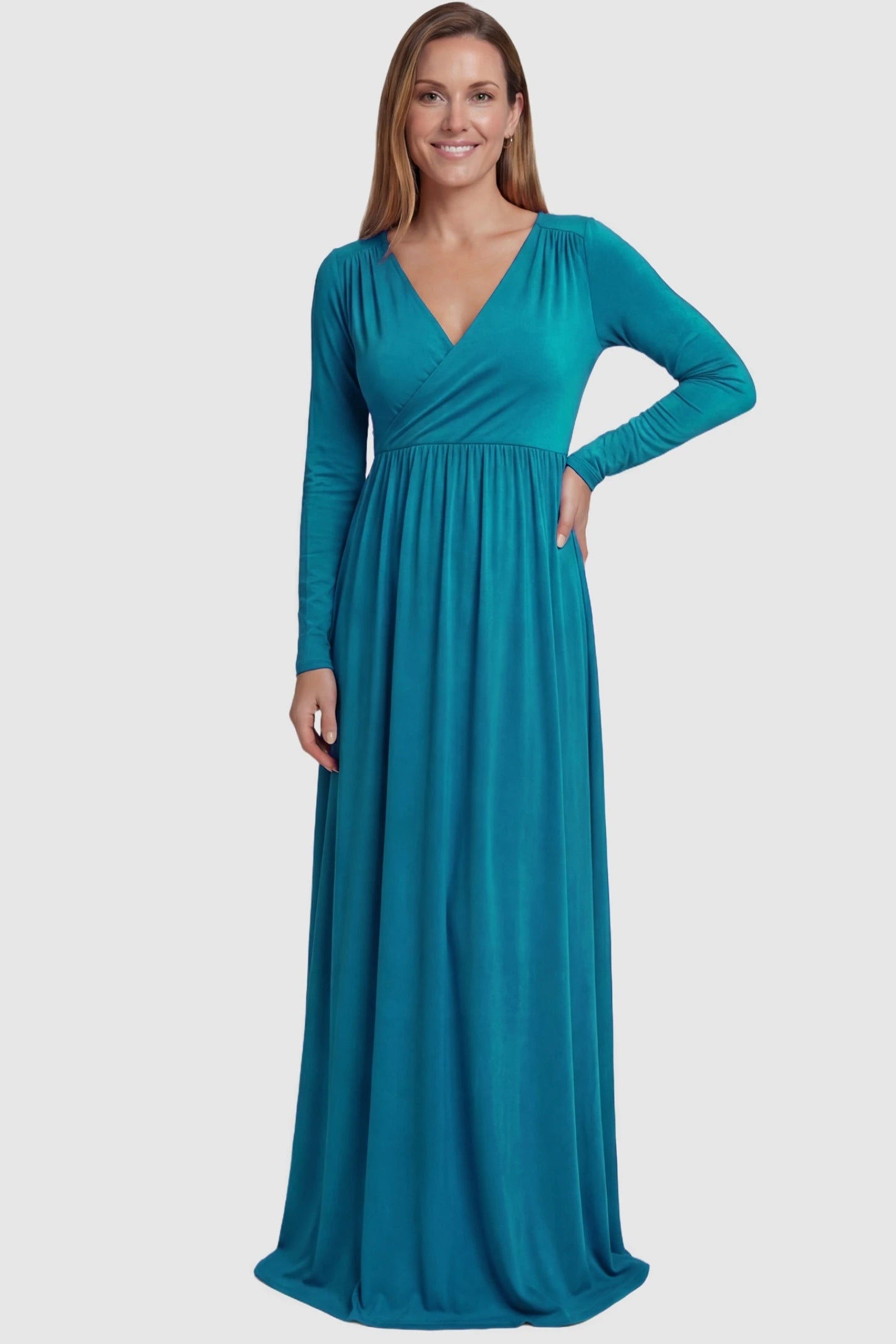 Off-Shoulder Long Sleeve Trailing Maxi Maternity Dress Off-shoulder long sleeve trailing maxi maternity dress in turquoise featuring dramatic full train and elegant long sleeves in full body view on a postpartum model