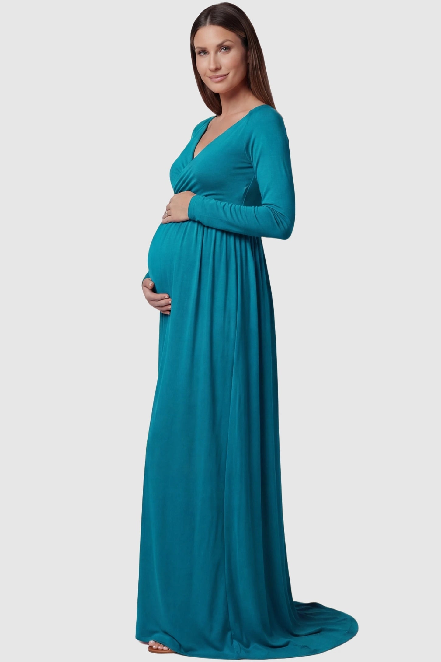 Off-Shoulder Long Sleeve Trailing Maxi Maternity Dress Off-shoulder long sleeve trailing maxi maternity dress in turquoise featuring elegant long sleeve silhouette in side view on a pregnant model