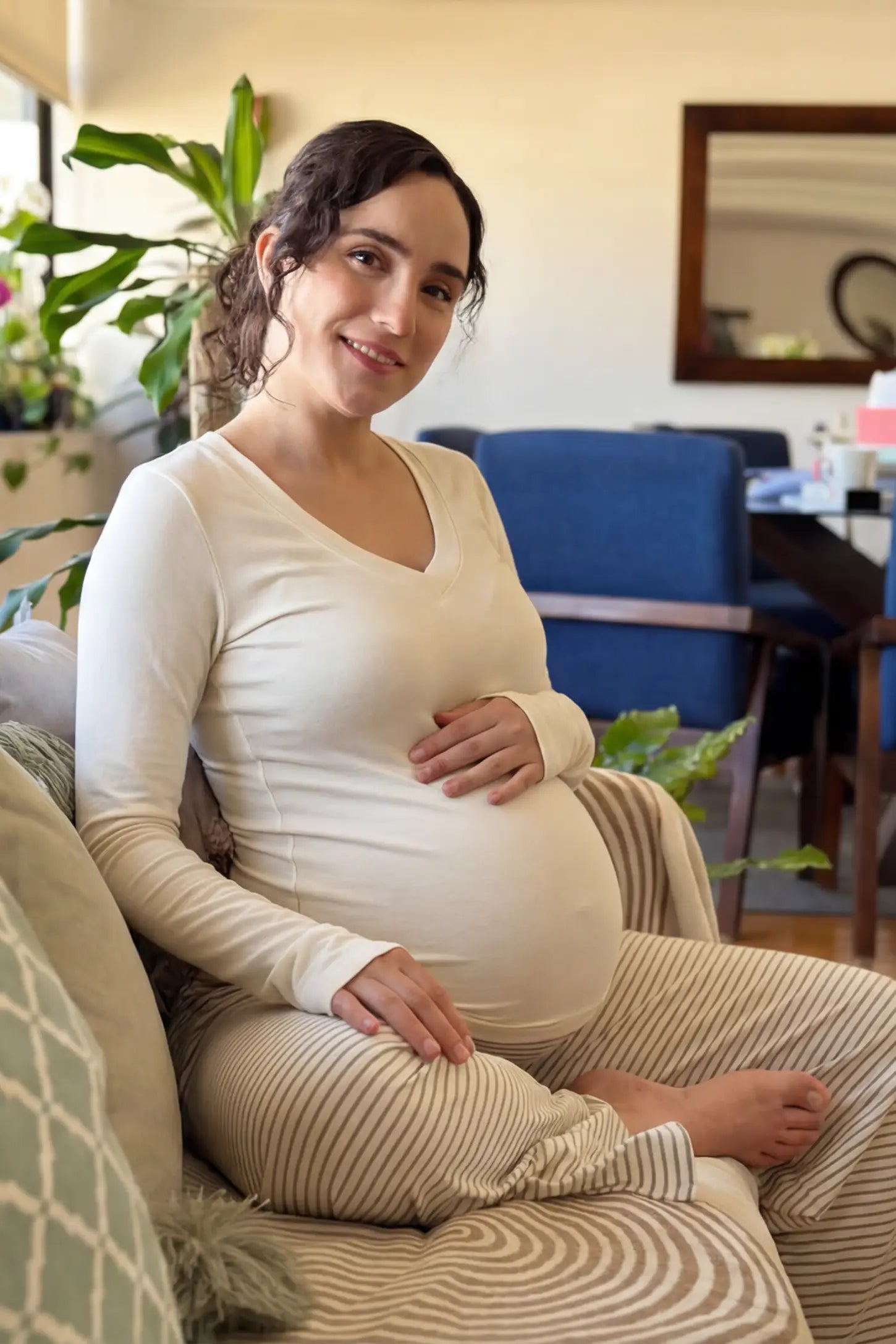 Soft Knit Long Sleeve V-Neck Maternity Top Soft knit long sleeve V-neck maternity top in white with flattering V-neckline and long sleeves, front view on pregnant model
