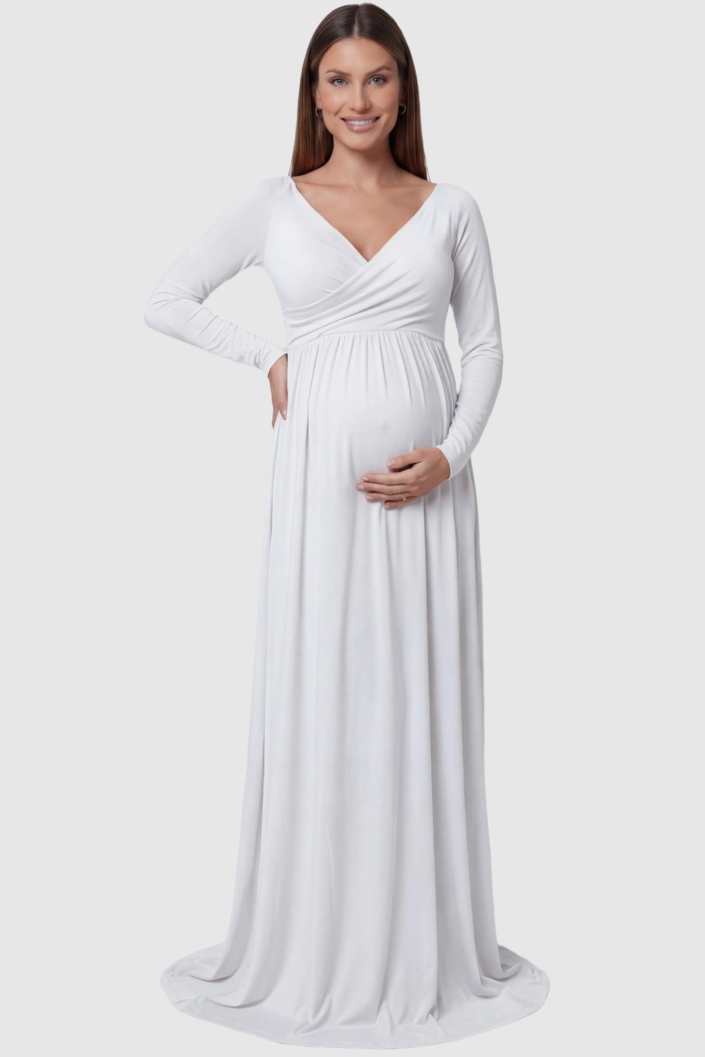 Off-Shoulder Long Sleeve Trailing Maxi Maternity Dress Off-shoulder long sleeve trailing maxi maternity dress in white featuring an elegant long sleeve silhouette in front view on a pregnant model