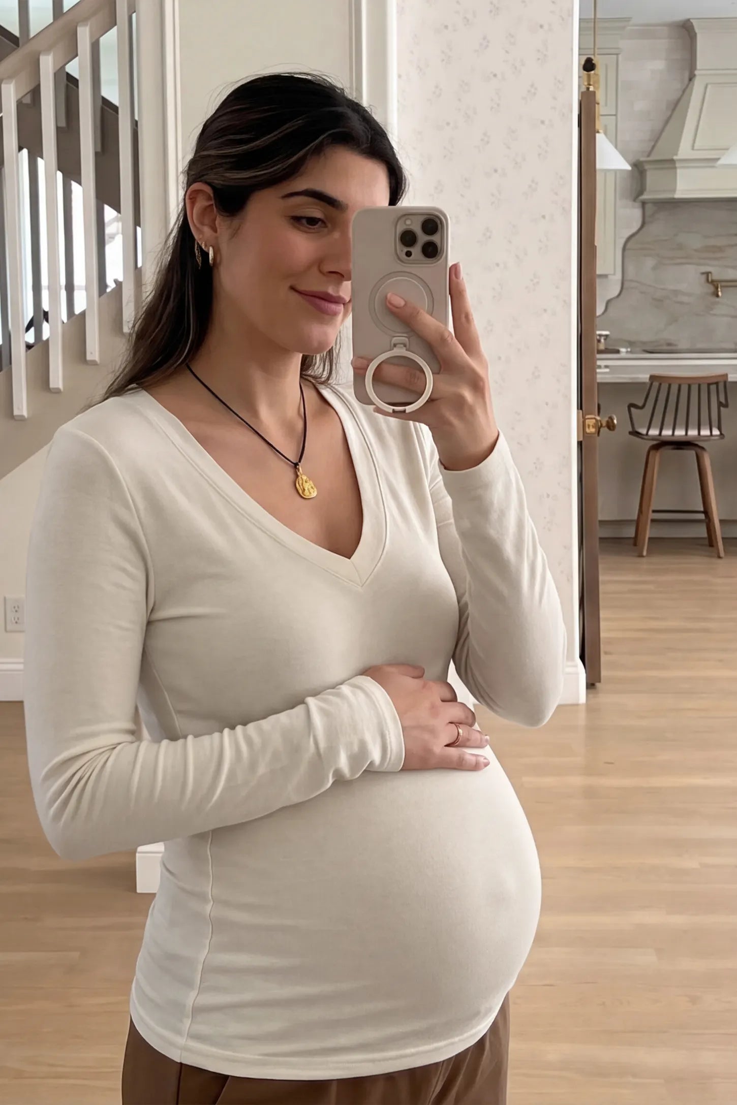 Soft Knit Long Sleeve V-Neck Maternity Top Soft knit long sleeve V-neck maternity top in white with flattering V-neckline and long sleeves, front view on pregnant model