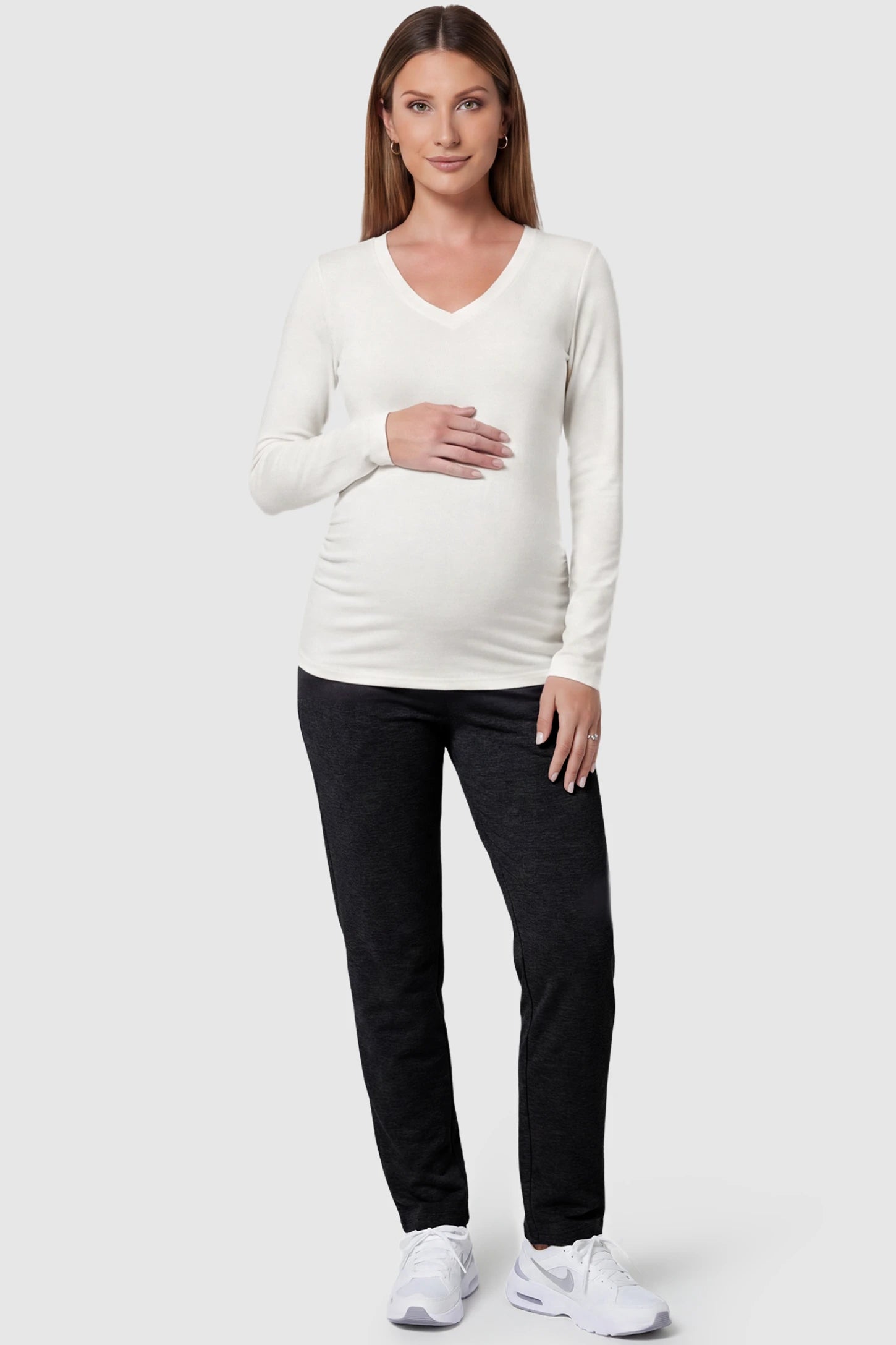 Soft Knit Long Sleeve V-Neck Maternity Top Soft knit long sleeve V-neck maternity top in white with flattering V-neckline and long sleeves, front view on pregnant model