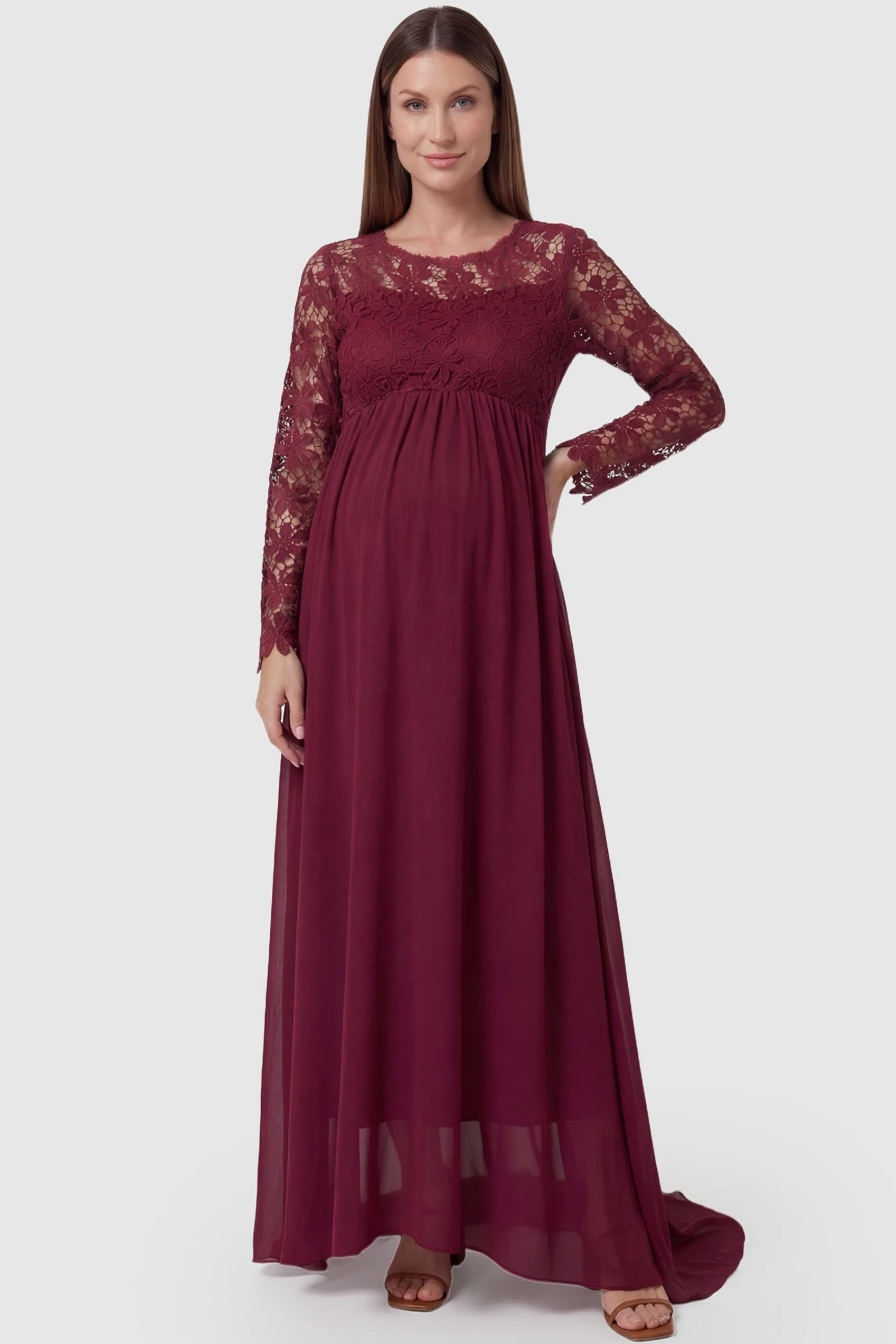 Lace Long Sleeve Full Skirt Maxi Maternity Dress Lace long sleeve full skirt maxi maternity dress in burgundy with elegant long sleeves & lace bodice, front view on pregnant model