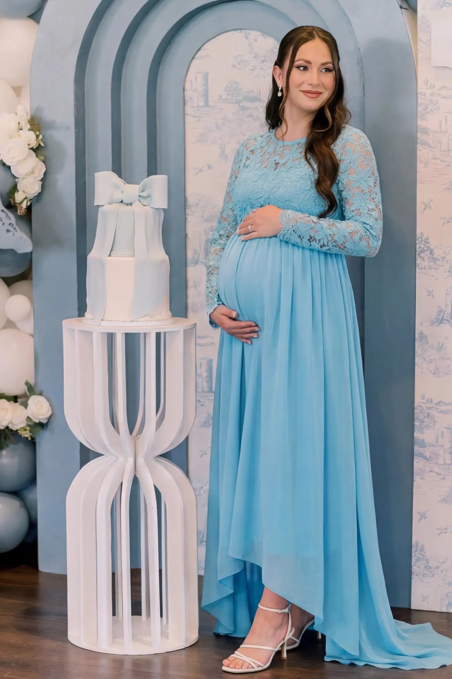 Lace Long Sleeve Full Skirt Maxi Maternity Dress Lace long sleeve full skirt maxi maternity dress in light blue with elegant long sleeves & lace bodice, front view on pregnant model