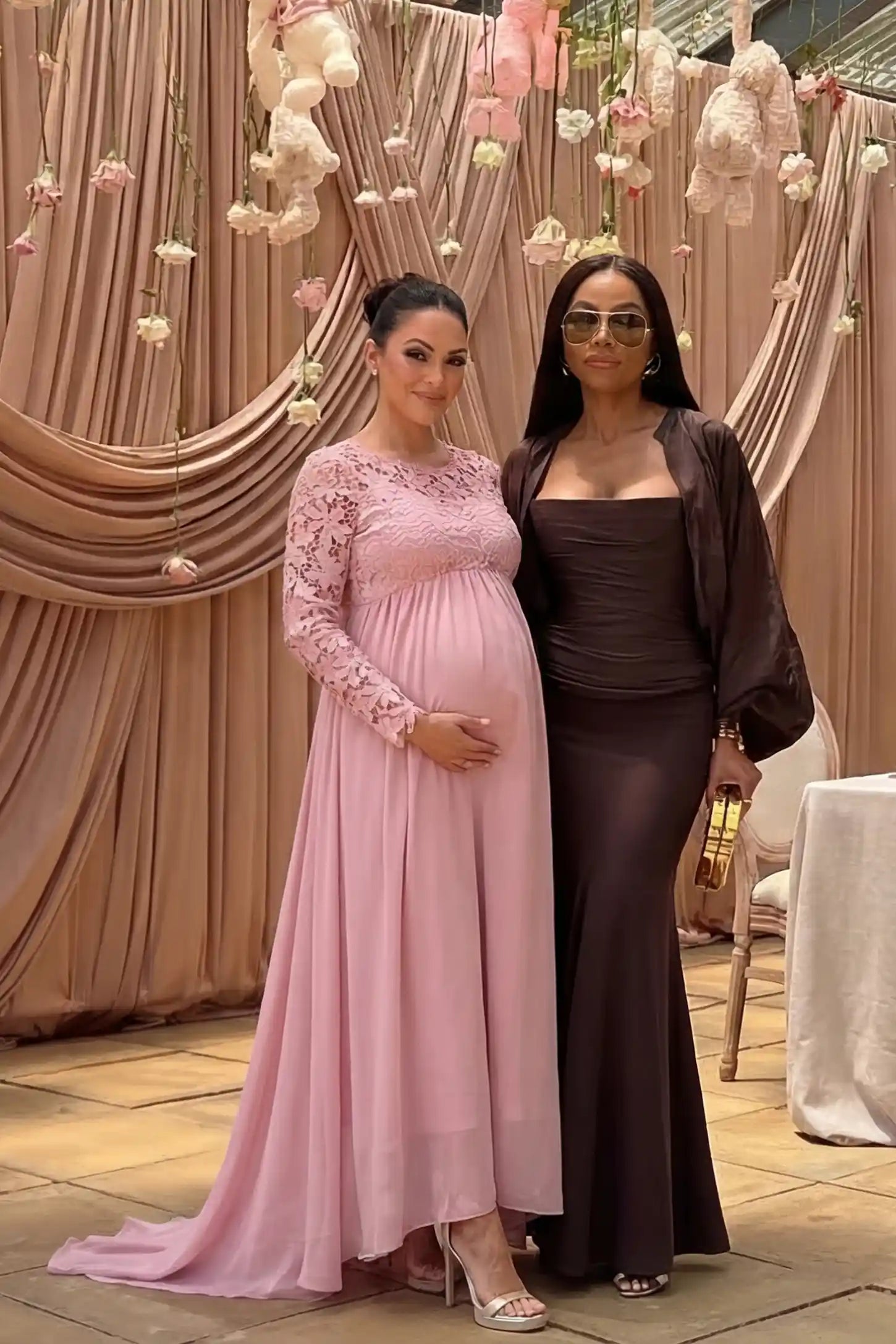 Lace Long Sleeve Full Skirt Maxi Maternity Dress Lace long sleeve full skirt maxi maternity dress in pink with elegant long sleeves & lace bodice, front view on pregnant model