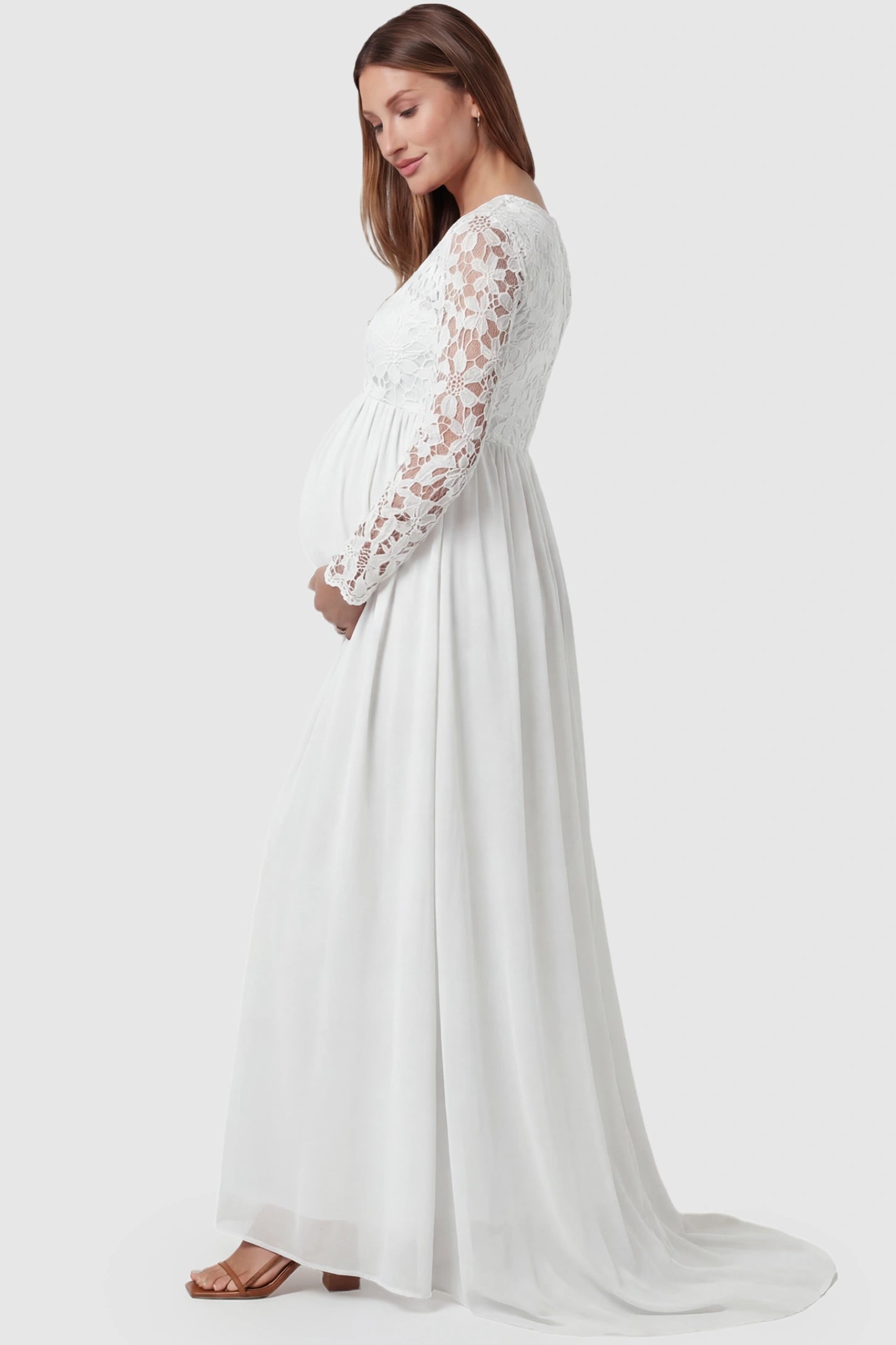 Lace Long Sleeve Full Skirt Maxi Maternity Dress Lace long sleeve full skirt maxi maternity dress in white with elegant long sleeves & lace bodice, side view on pregnant model