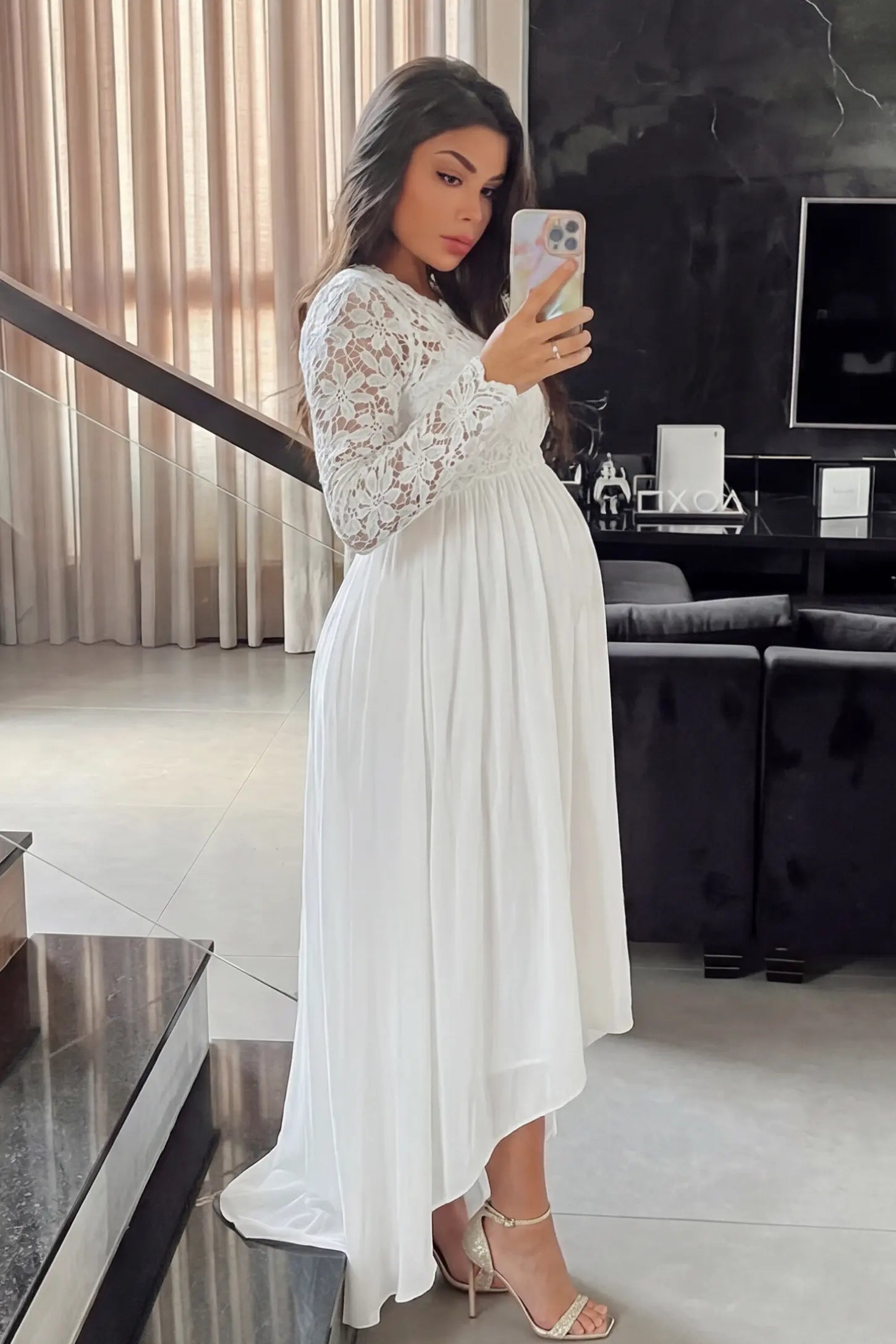 Lace Long Sleeve Full Skirt Maxi Maternity Dress Lace long sleeve full skirt maxi maternity dress in white with elegant long sleeves & lace bodice, side view on pregnant model