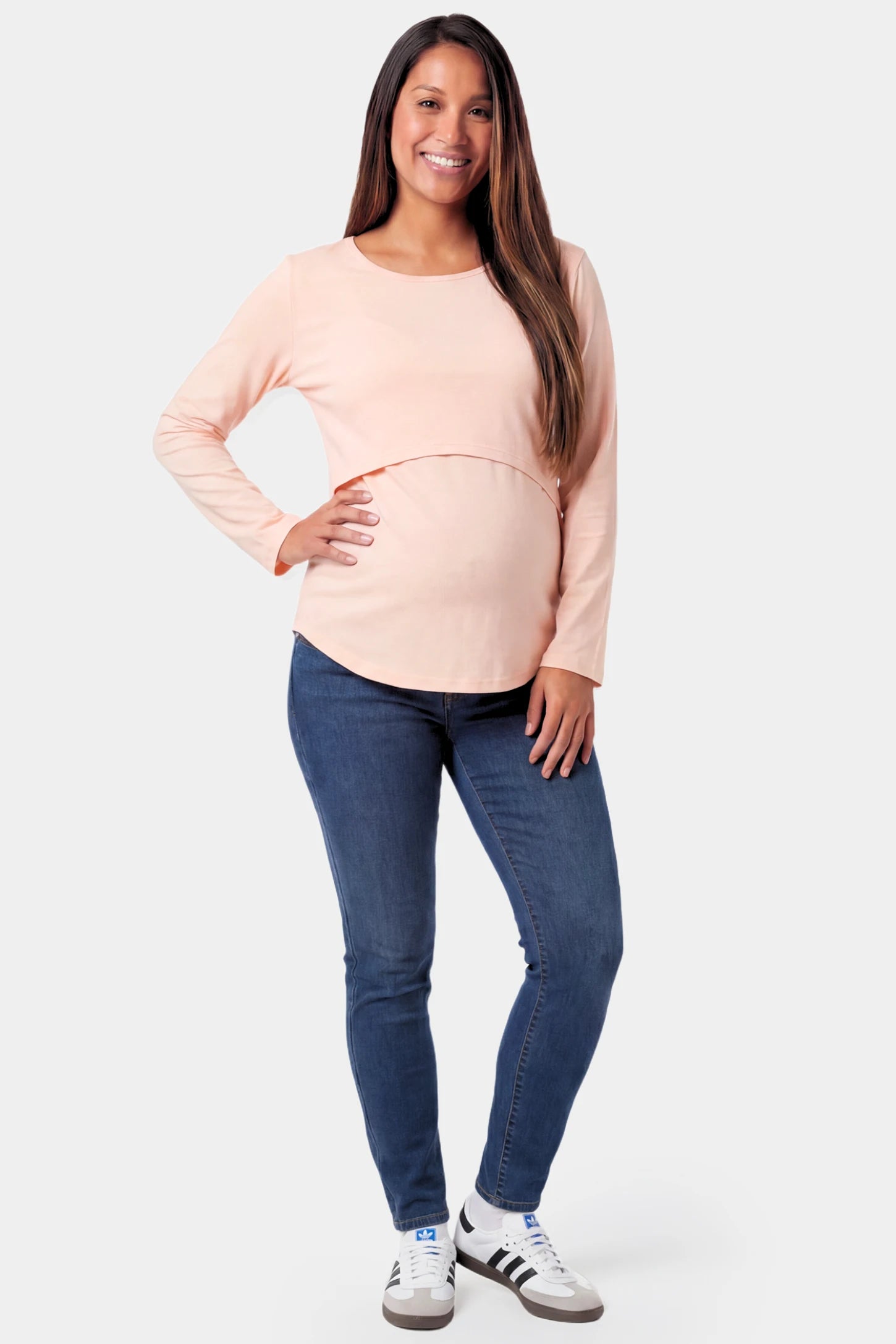 Basic Long Sleeve Maternity & Nursing Top Basic Long Sleeve Maternity & Nursing Top in pink featuring a relaxed crew neck and nursing-friendly design on a pregnant model.