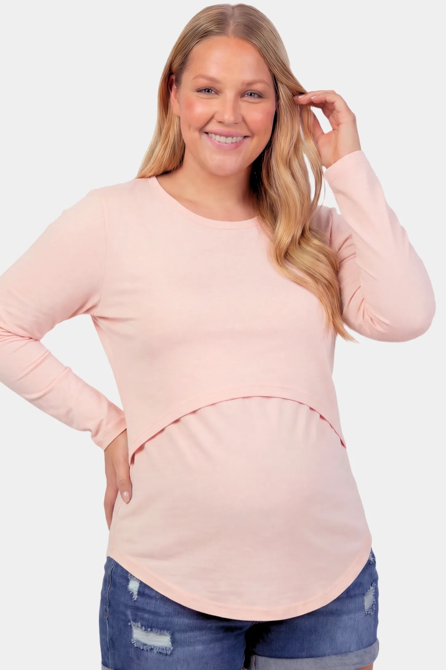 Basic Long Sleeve Maternity & Nursing Top Basic Long Sleeve Maternity & Nursing Top in pink featuring a relaxed crew neck and nursing-friendly design on a pregnant model.