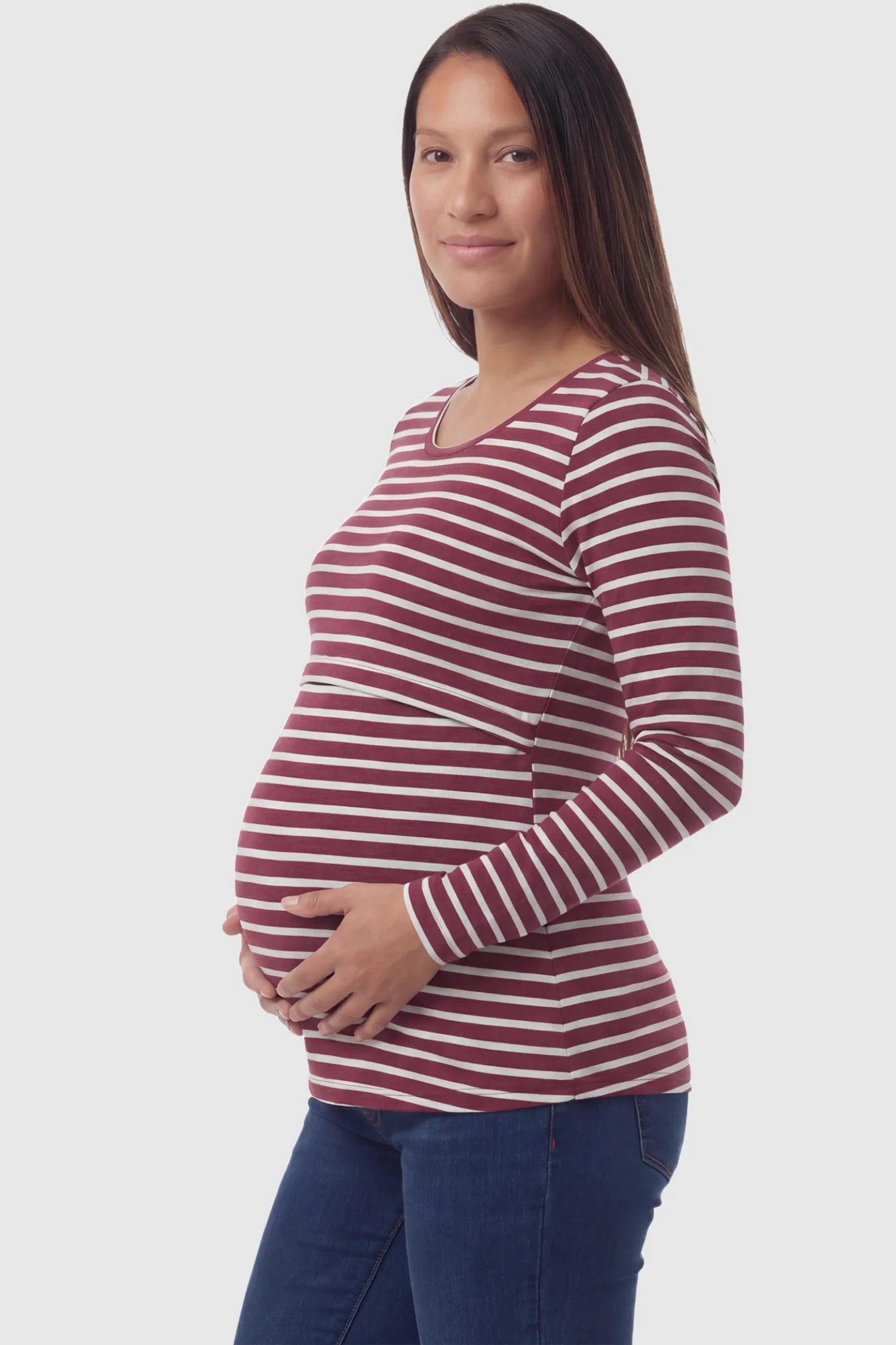 Pull up nursing opening scoop neck maternity and nursing top in burgundy featuring striped print & long-sleeve shown in side view on a pregnant model