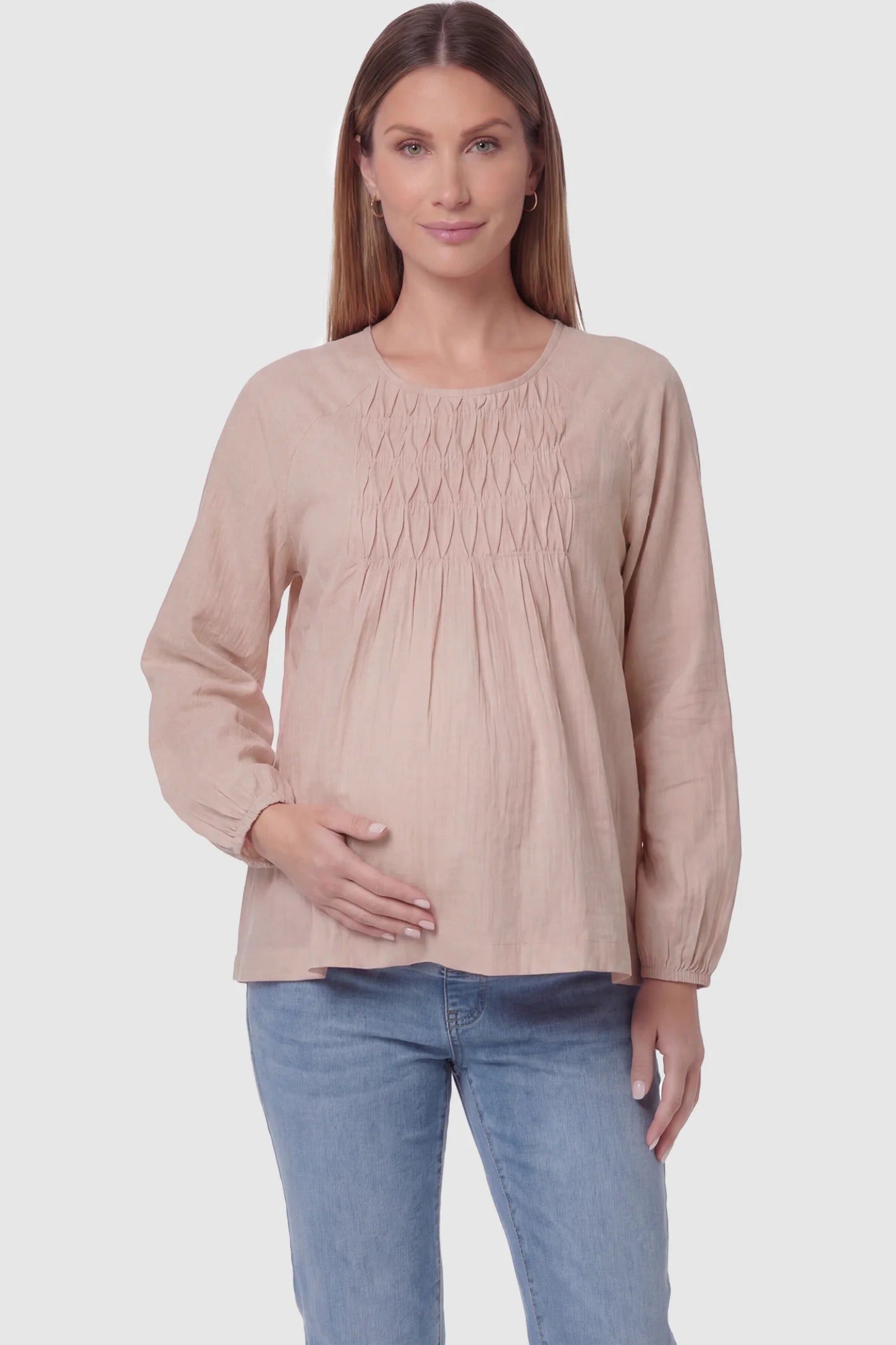 Long sleeve round neck maternity blouse in pink with classic round neckline, front view on pregnant model