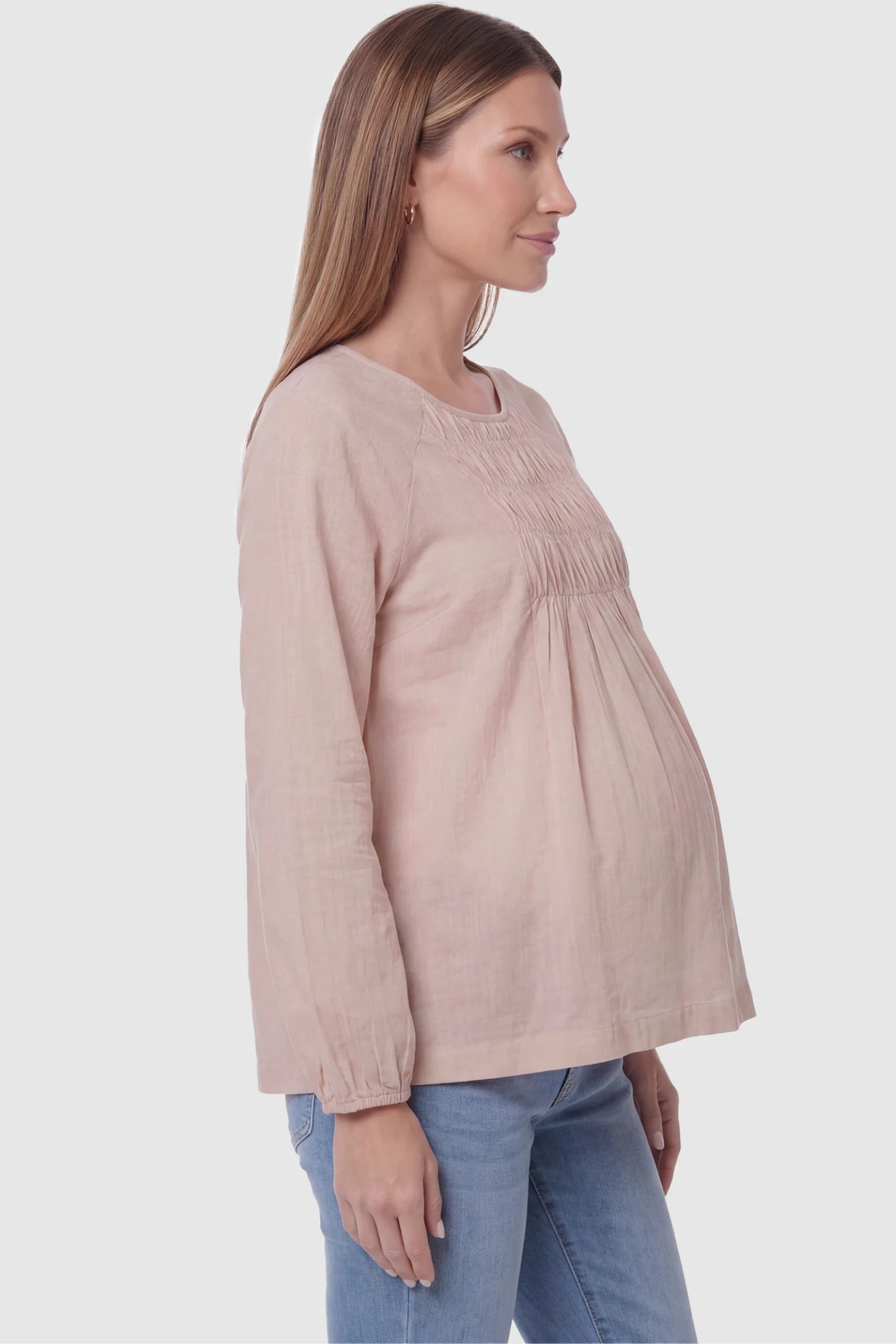 Long sleeve round neck maternity blouse in pink with elegant long sleeve, side view on pregnant model