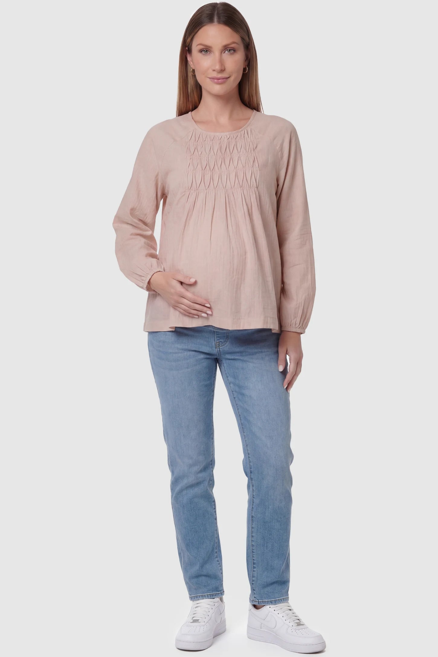 Long Sleeve Round Neck Maternity Blouse Long sleeve round neck maternity blouse in pink with classic round neckline and long sleeve, front view on pregnant model