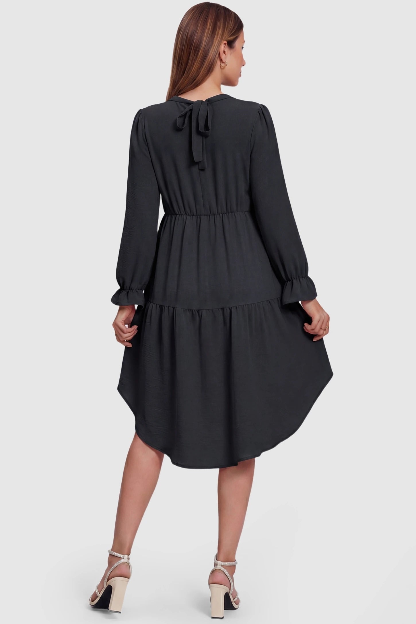 Fishtail Hem Tie-Back Maternity Mini Dress Fishtail Hem Tie-Back Maternity Mini Dress in Black featuring an adjustable tie-back on a pregnant model.