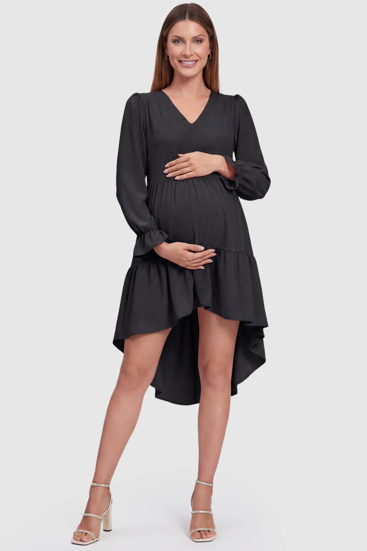 Fishtail Hem Tie-Back Maternity Mini Dress Fishtail Hem Tie-Back Maternity Mini Dress in Black featuring a V-neck and ruffled hem on a pregnant model.