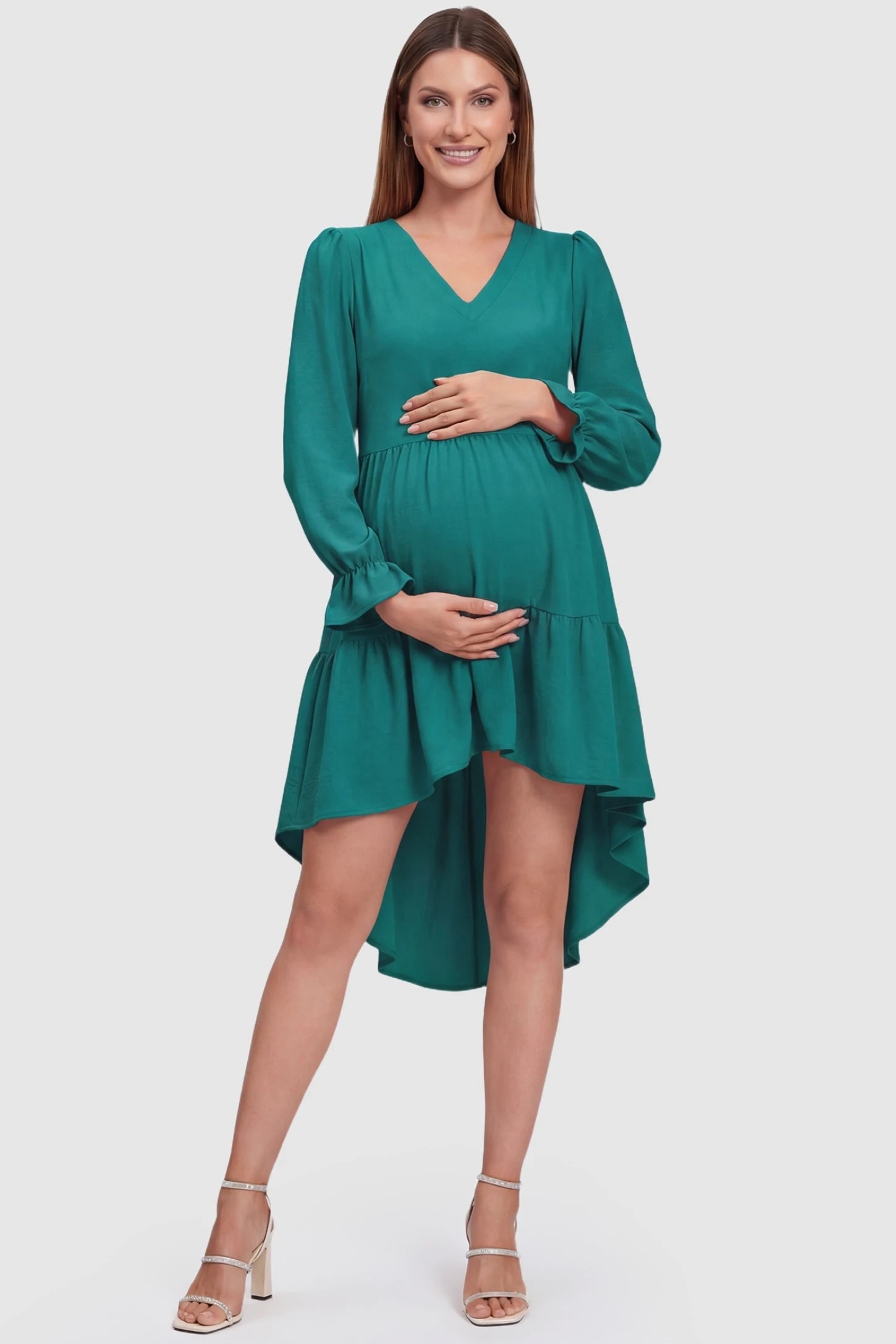 Fishtail Hem Tie-Back Maternity Mini Dress Fishtail Hem Tie-Back Maternity Mini Dress in Green featuring a V-neck and tiered skirt on a pregnant model.