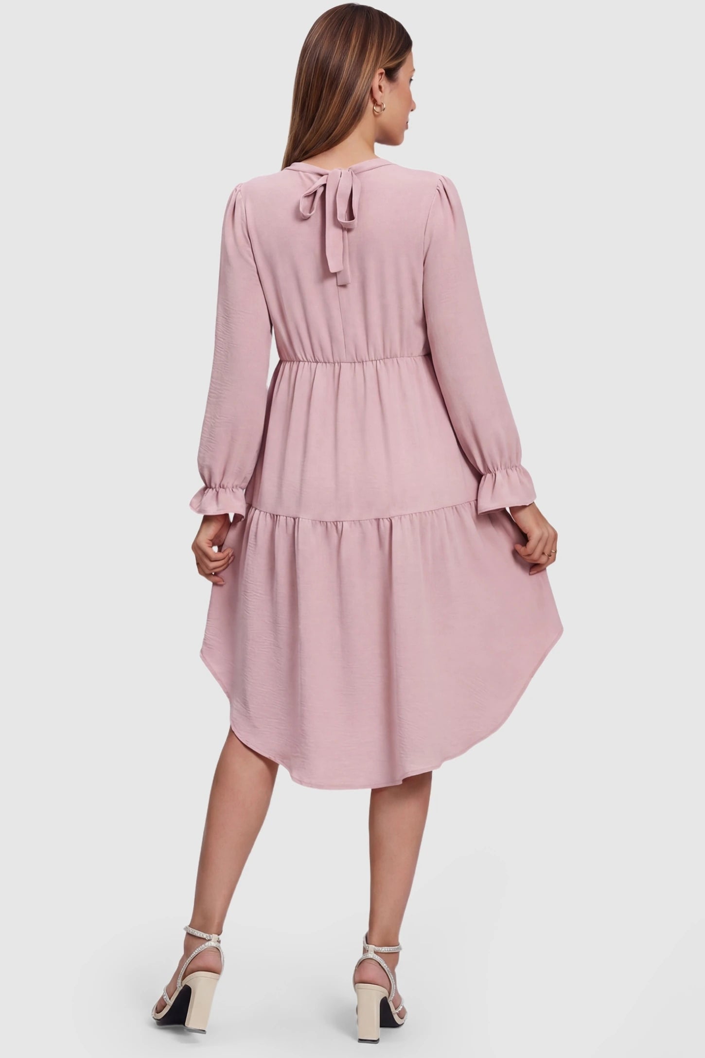 Fishtail Hem Tie-Back Maternity Mini Dress Fishtail Hem Tie-Back Maternity Mini Dress in Pink featuring an adjustable back-tie on a pregnant model.