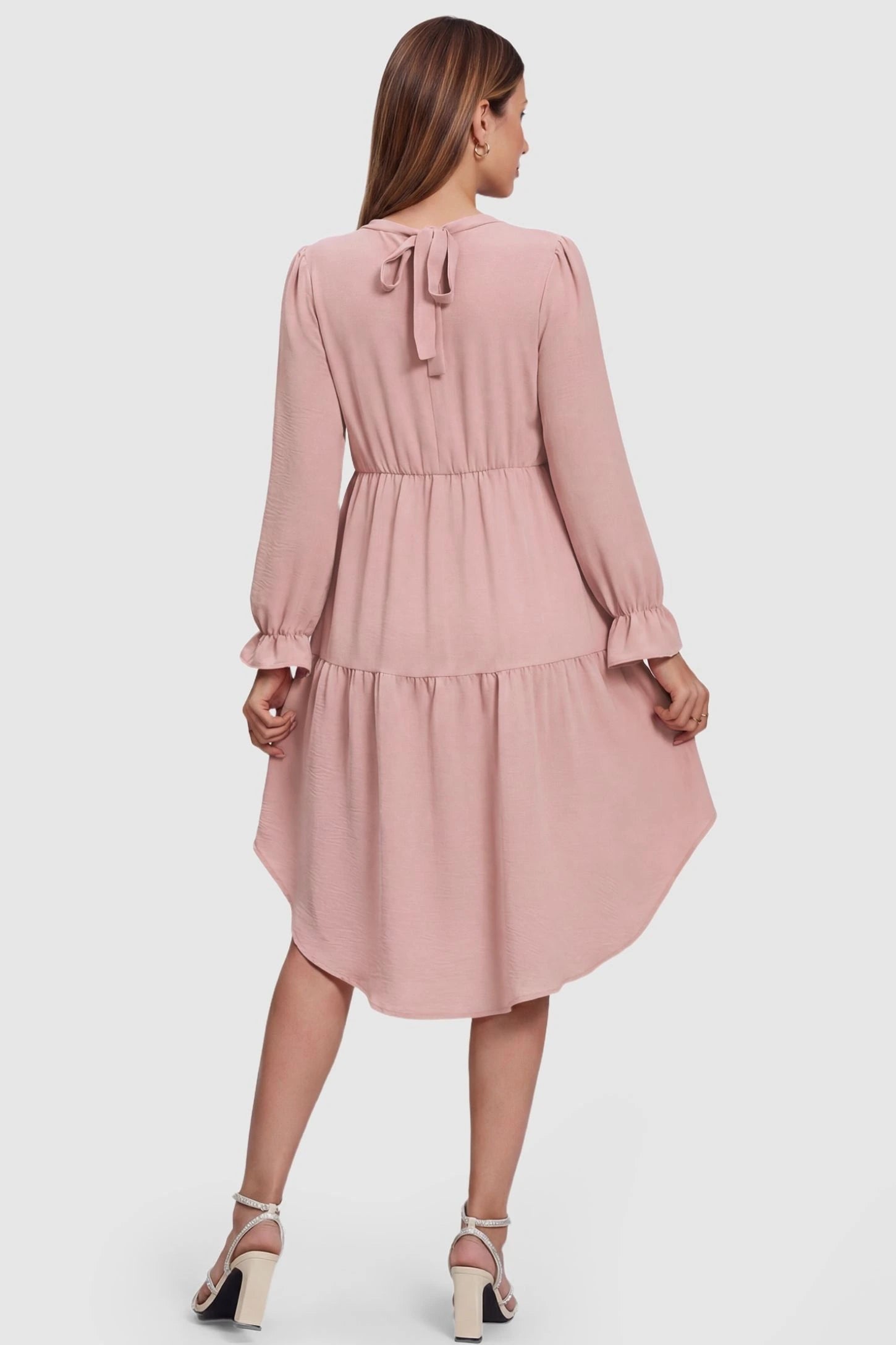 Fishtail Hem Tie-Back Maternity Mini Dress Fishtail Hem Tie-Back Maternity Mini Dress in Pink featuring an adjustable back-tie on a pregnant model, back view.