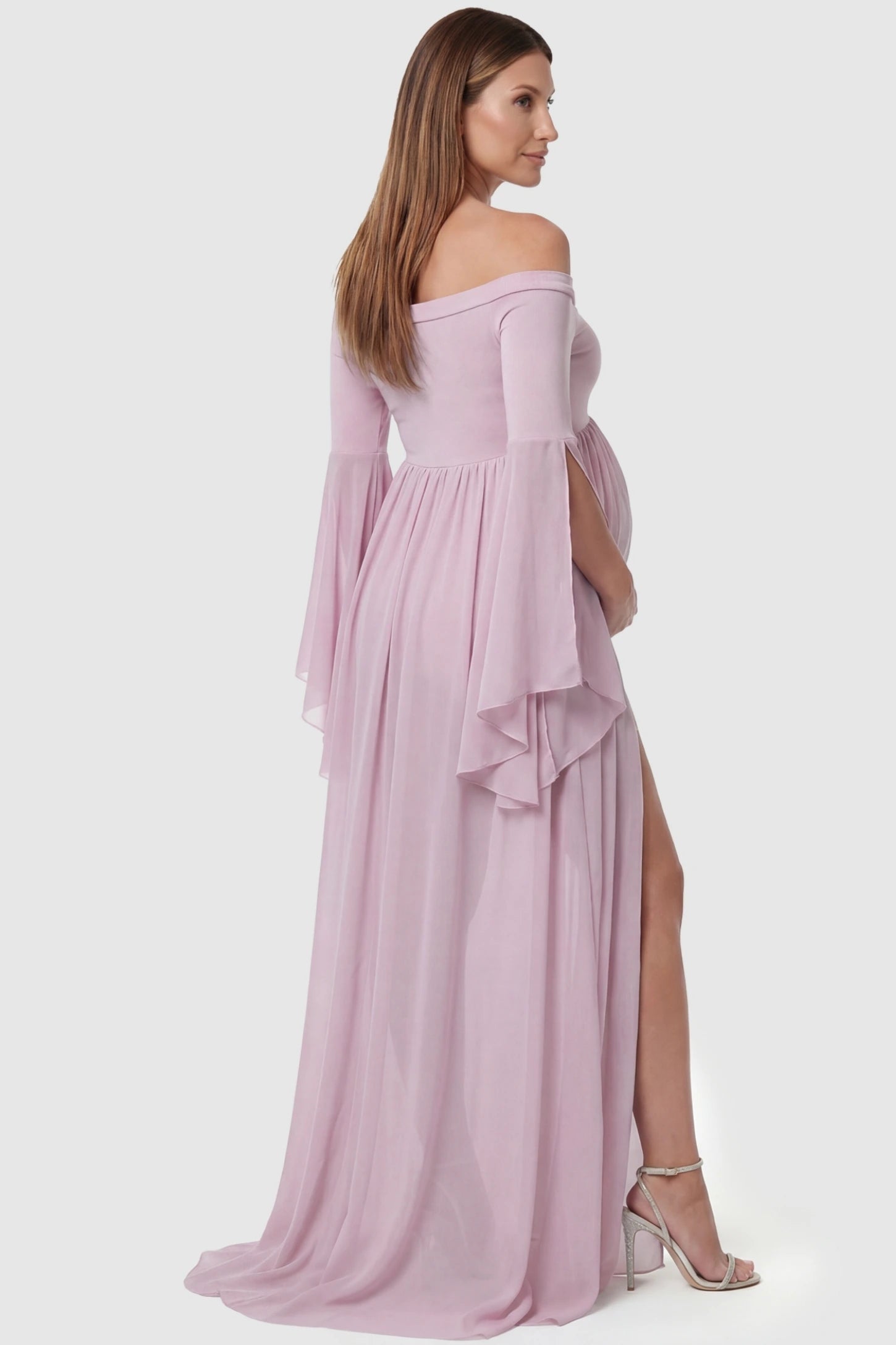 Off-the-Shoulder Long Train Maxi Maternity Dress Off-the-shoulder long train maxi maternity dress in pink featuring flowing chiffon silhouette in full body back view on a pregnant model