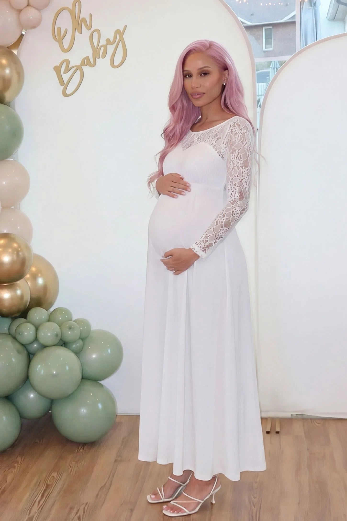 Acrylic Lace Long Sleeve Floor-Length Maternity Dress Acrylic Lace Long Sleeve Floor-Length Maternity Dress in White featuring a round neck on a pregnant model.
