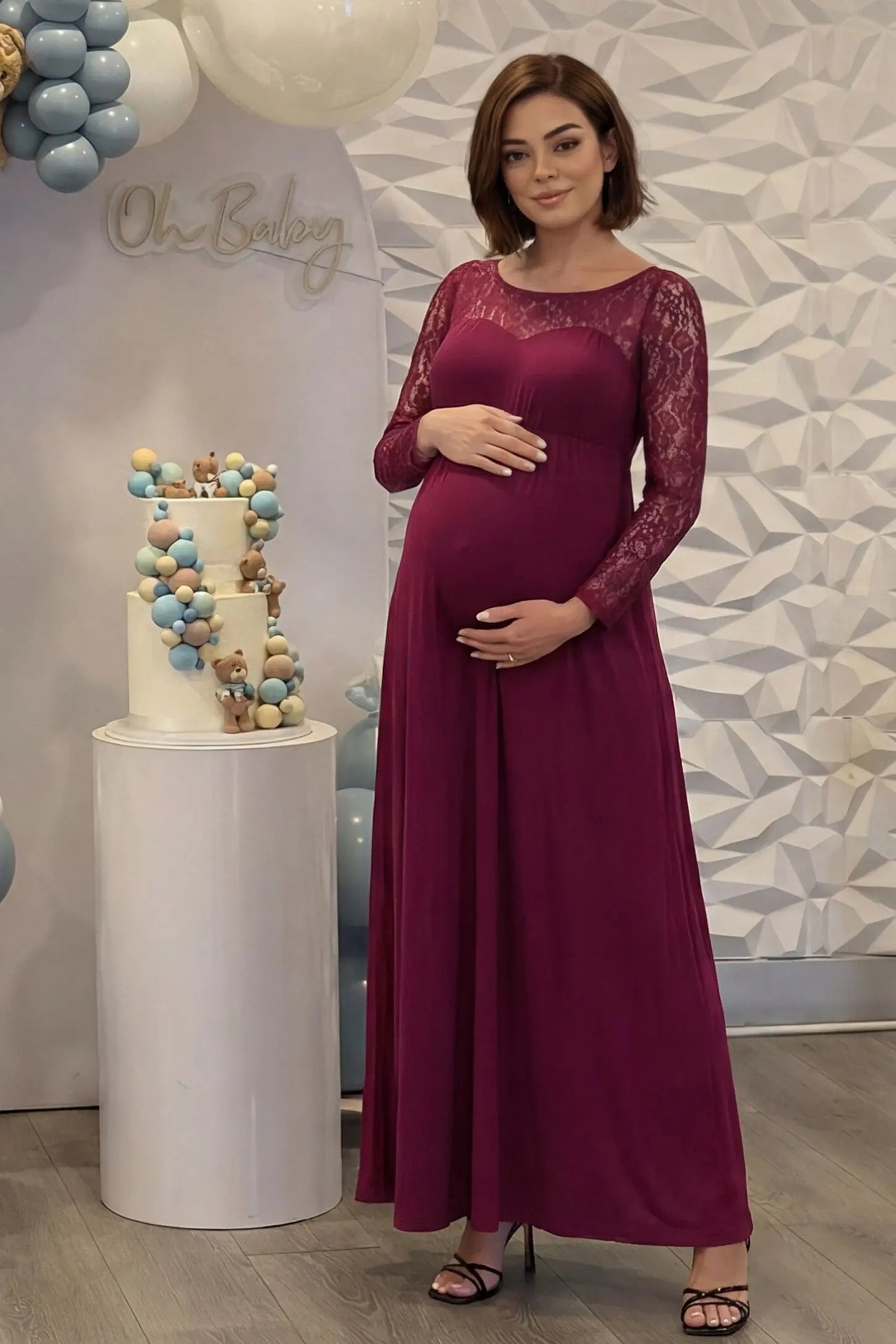Acrylic Lace Long Sleeve Floor-Length Maternity Dress Acrylic Lace Long Sleeve Floor-Length Maternity Dress in Wine Red featuring a round neck on a pregnant model.