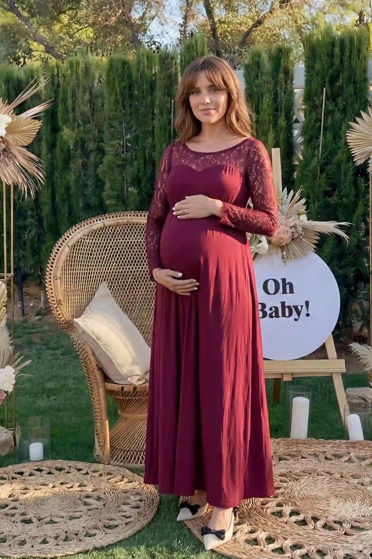 Acrylic Lace Long Sleeve Floor-Length Maternity Dress Acrylic Lace Long Sleeve Floor-Length Maternity Dress in Wine Red featuring a round neck on a pregnant model.