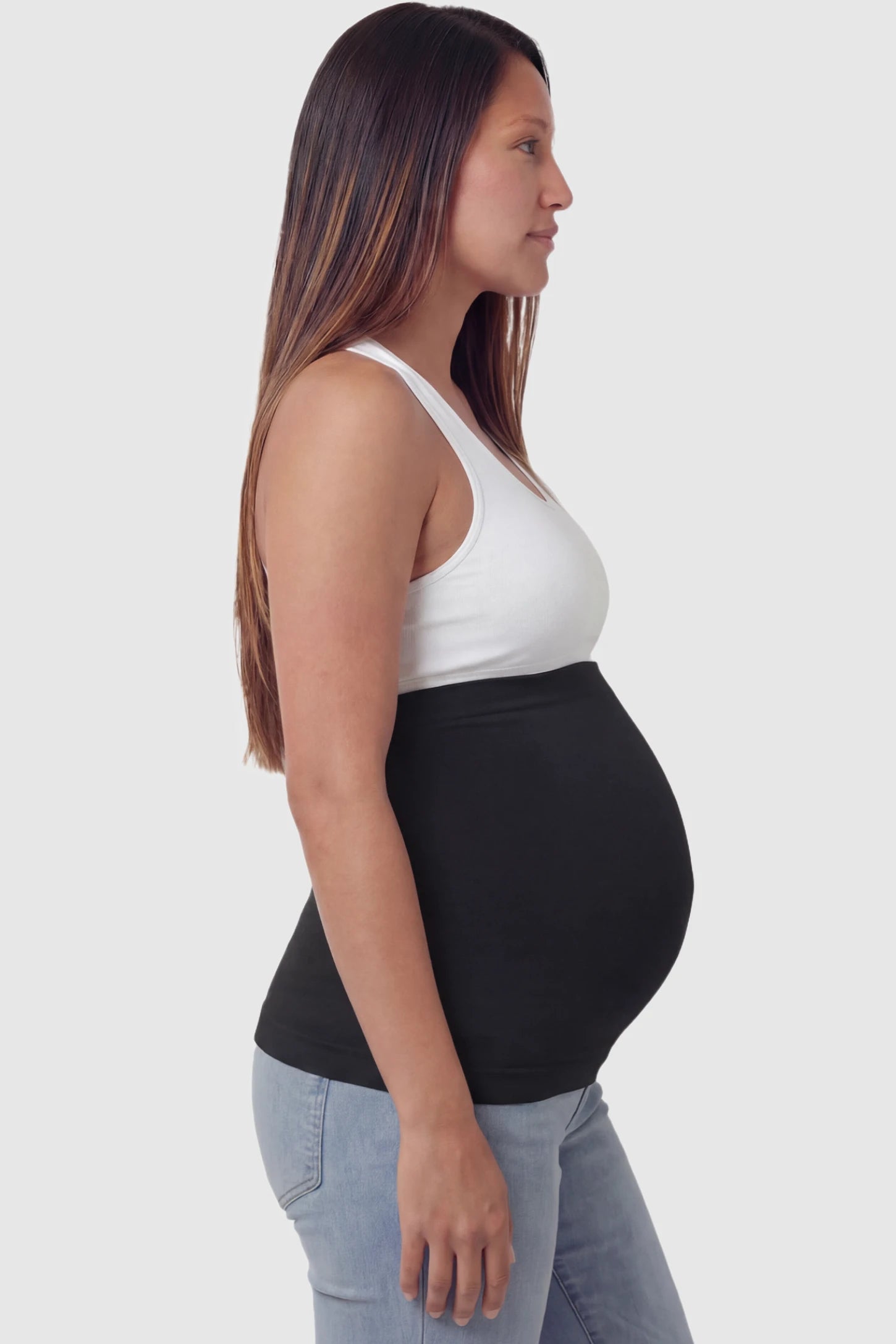 Seamless Support Maternity Belly Band in black featuring wide high-rise fit and seamless tubular design on pregnant model.