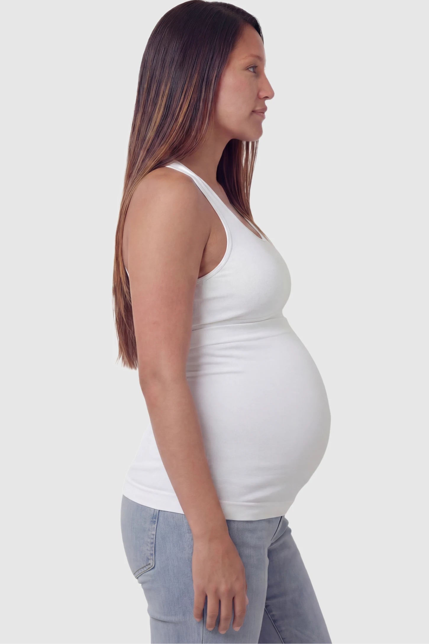 Seamless Support Maternity Belly Band Seamless Support Maternity Belly Band in white featuring wide high-rise fit and seamless tubular design on pregnant model.