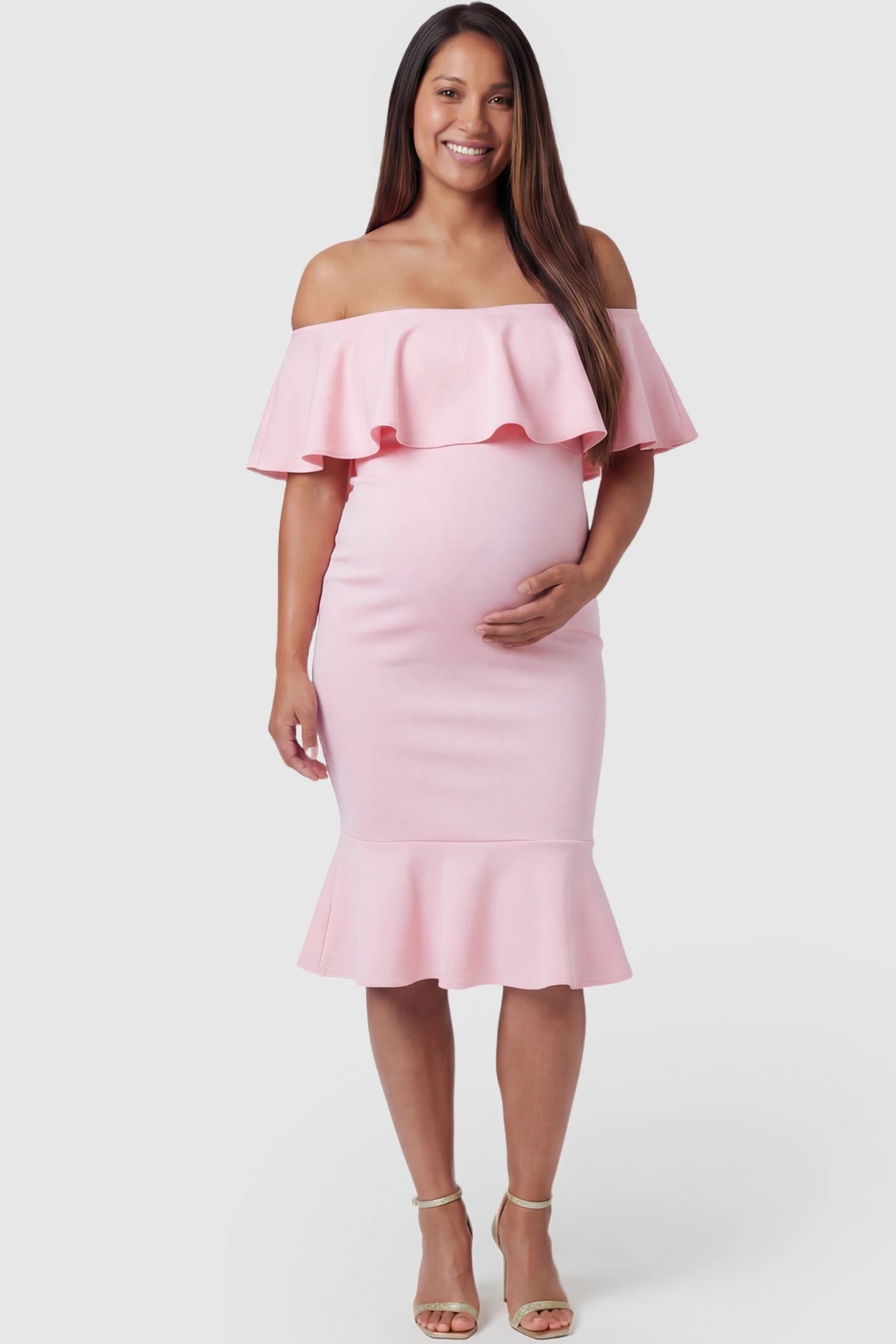 Ruffled Off-Shoulder Mermaid Hem Midi Maternity Dress Ruffled off-shoulder mermaid hem midi maternity dress in pink featuring retro-inspired ruffles in front view on a pregnant model