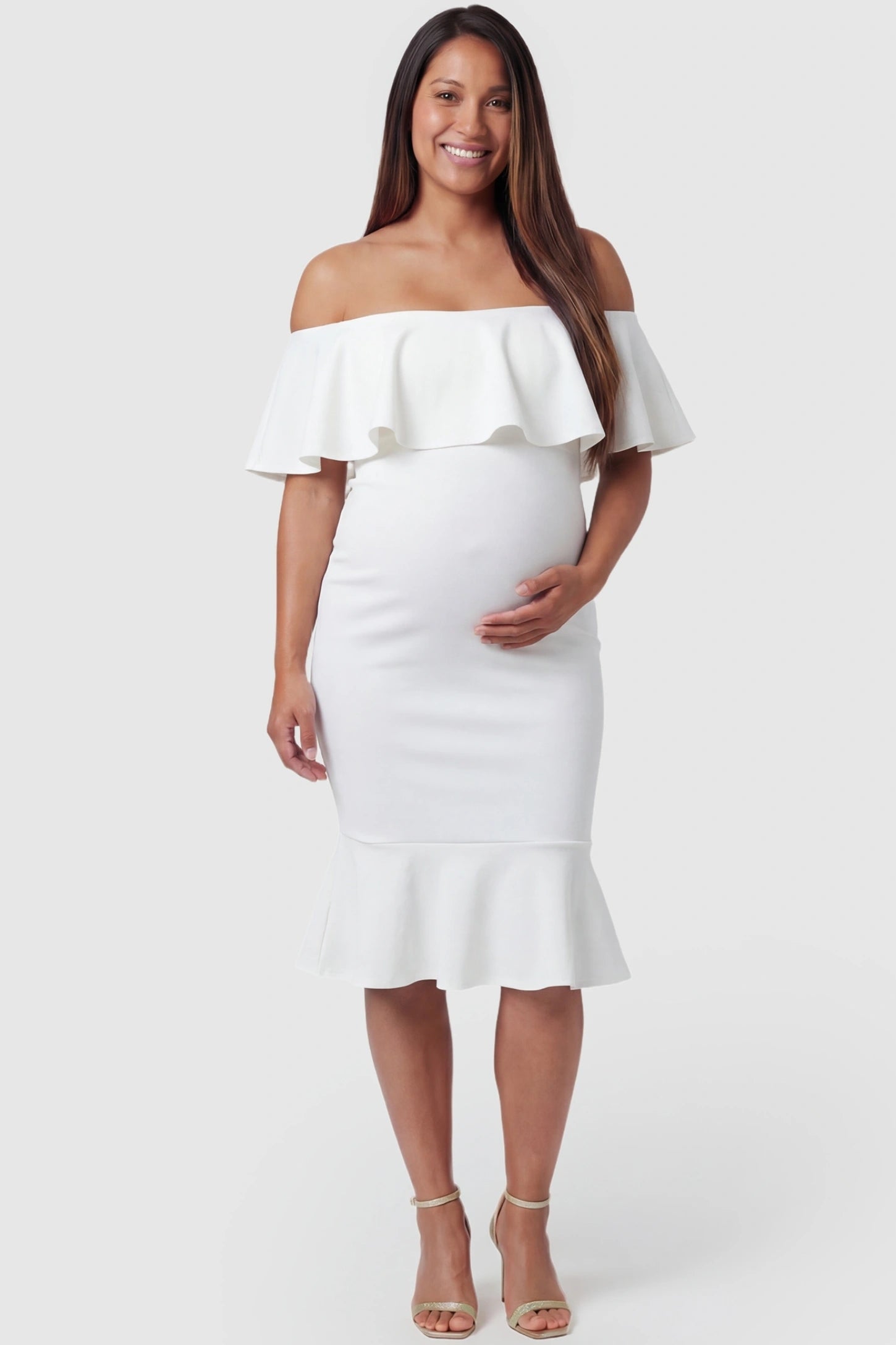 Ruffled Off-Shoulder Mermaid Hem Midi Maternity Dress Ruffled off-shoulder mermaid hem midi maternity dress in white featuring retro-inspired ruffles in front view on a pregnant model