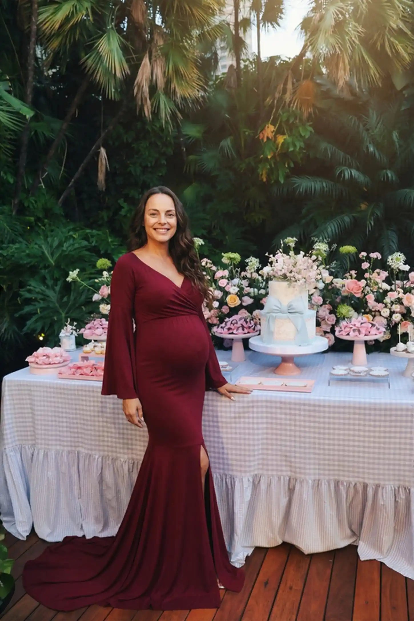 Mesh Flared Fishtail Maternity Gown Burgundy Mesh Flared Fishtail Maternity Gown featuring a V-neckline and bell sleeves on a pregnant model in a front view.