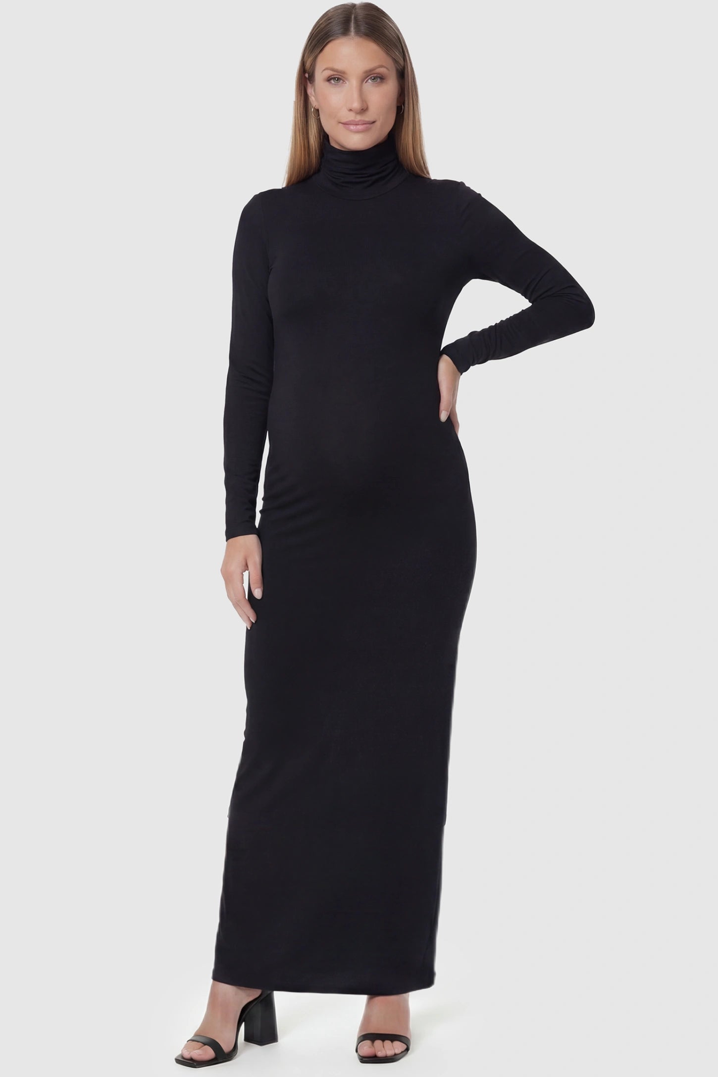 Fitted Long Sleeve Mock Neck Maxi Maternity Dress Fitted long sleeve mock neck maxi maternity dress in black with mock neckline, front view on pregnant model