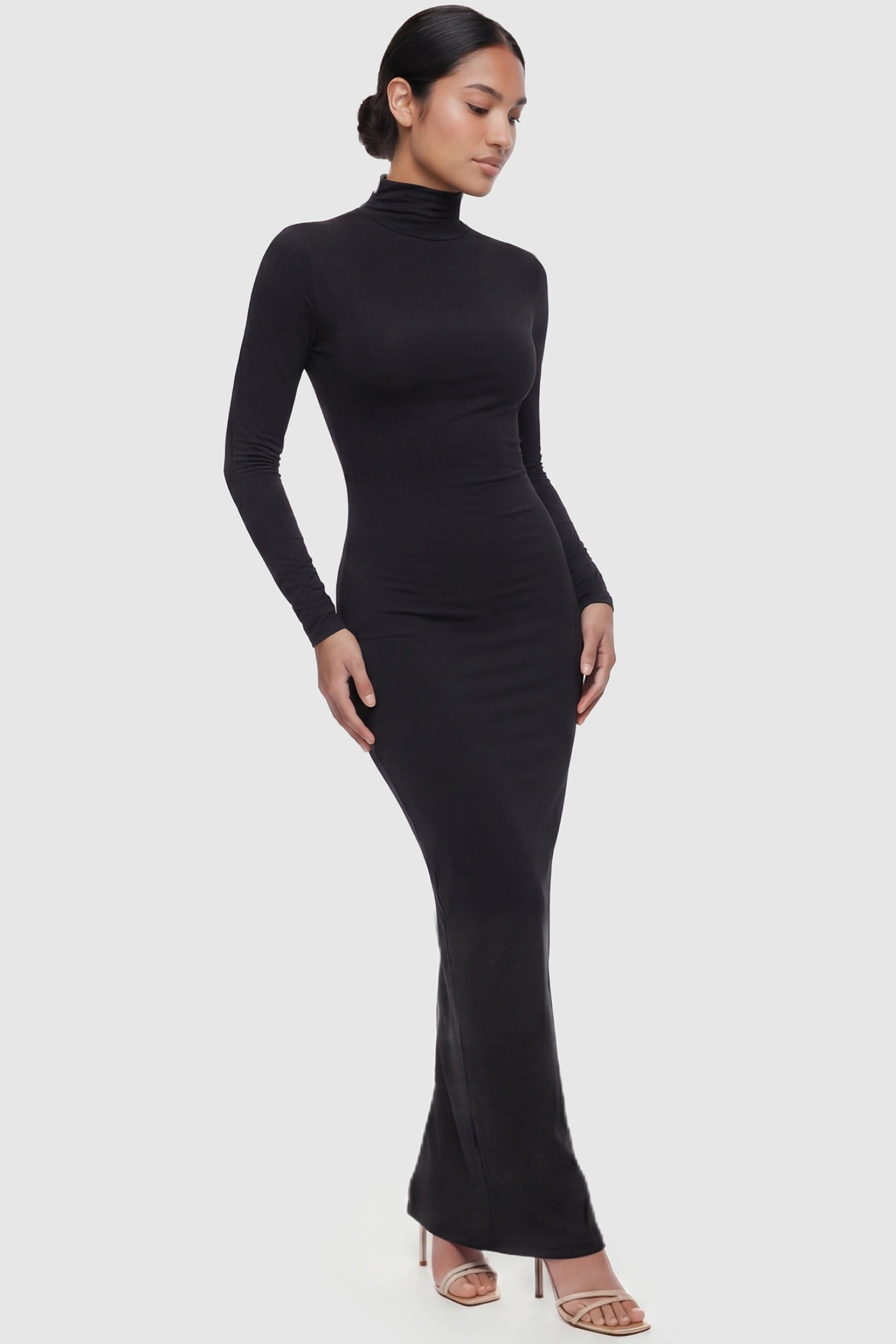 Fitted Long Sleeve Mock Neck Maxi Maternity Dress Fitted long sleeve mock neck maxi maternity dress in black with mock neckline, front view on postpartum model