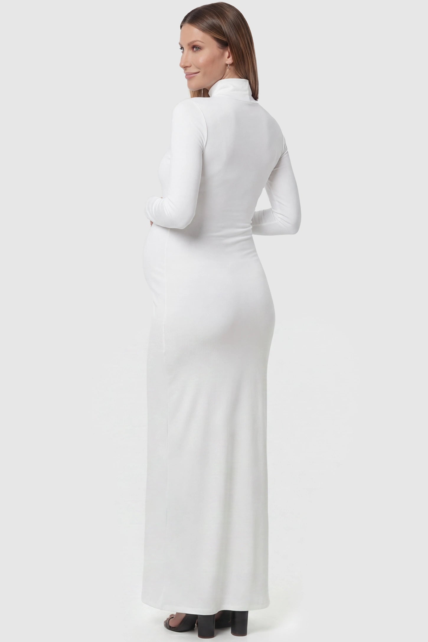 Fitted Long Sleeve Mock Neck Maxi Maternity Dress Fitted long sleeve mock neck maxi maternity dress in white with mock neckline, back view on pregnant model