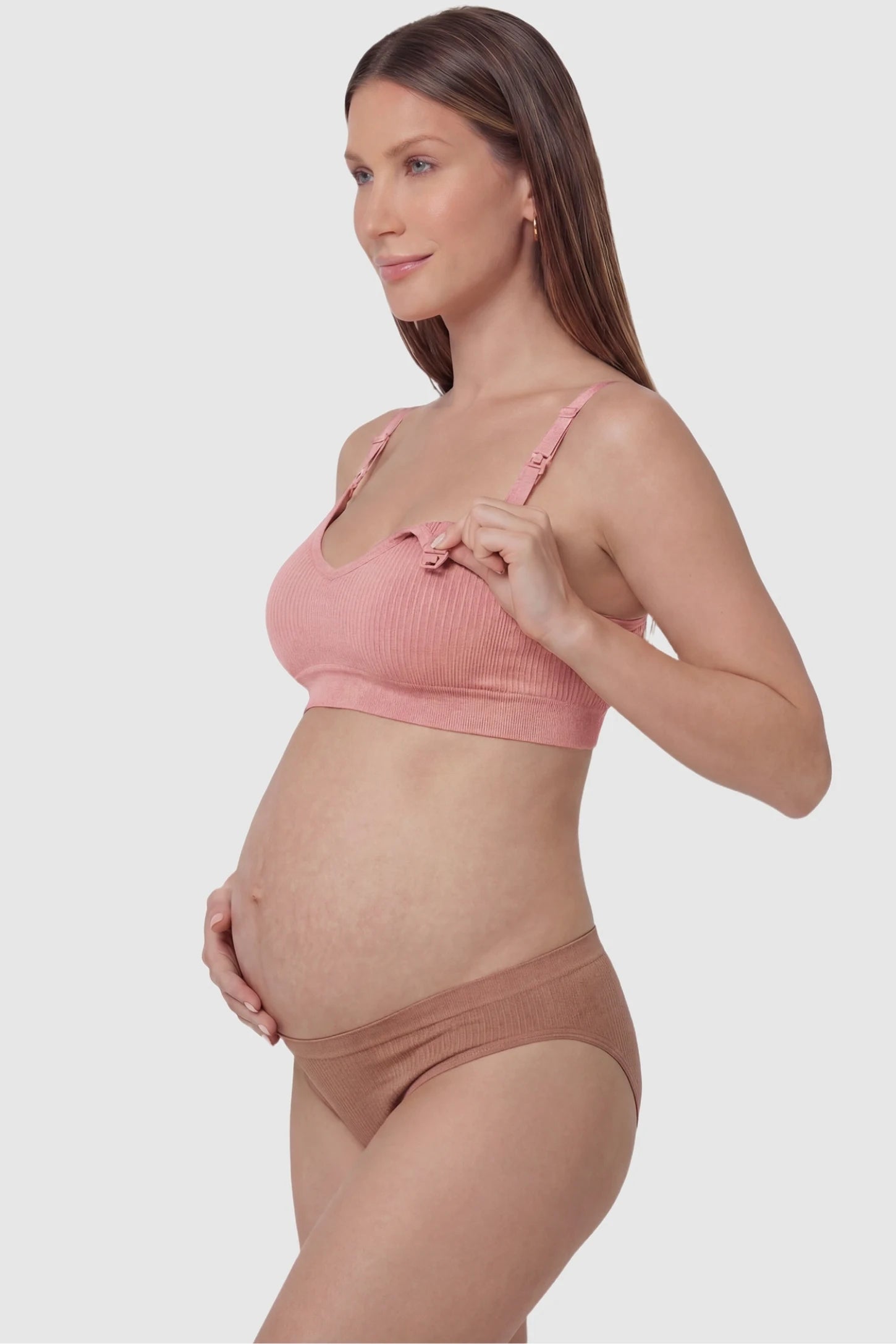 Ribbed Wireless Adjustable Shoulder Strap Nursing Bra Ribbed wireless adjustable strap nursing bra in bean paste with front open clasp for breastfeeding, side view on pregnant model