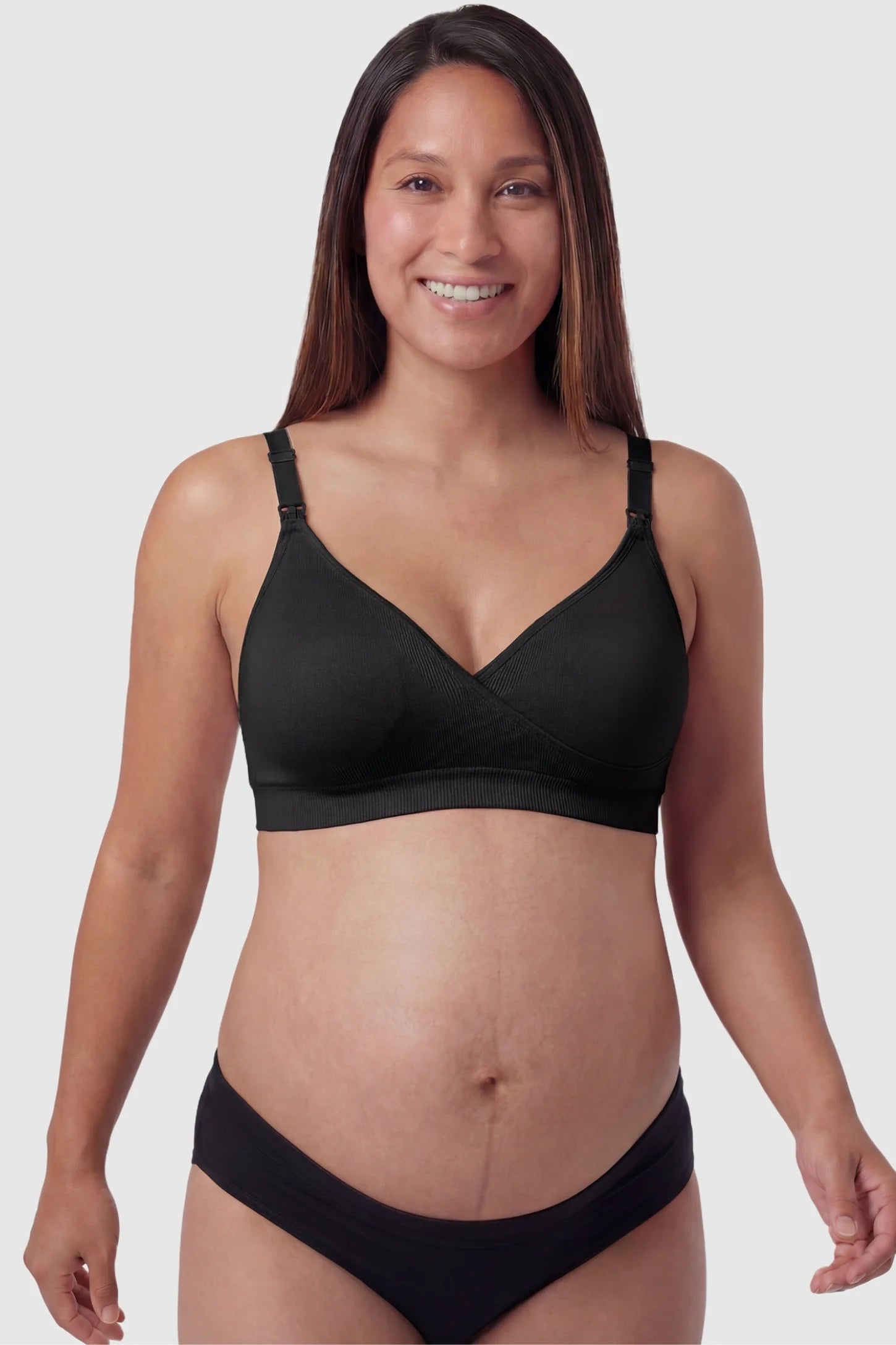 Seamless Front-Open Cross Wireless Nursing Bra Seamless front-open cross wireless nursing bra in black with cross front access, front view on pregnant model