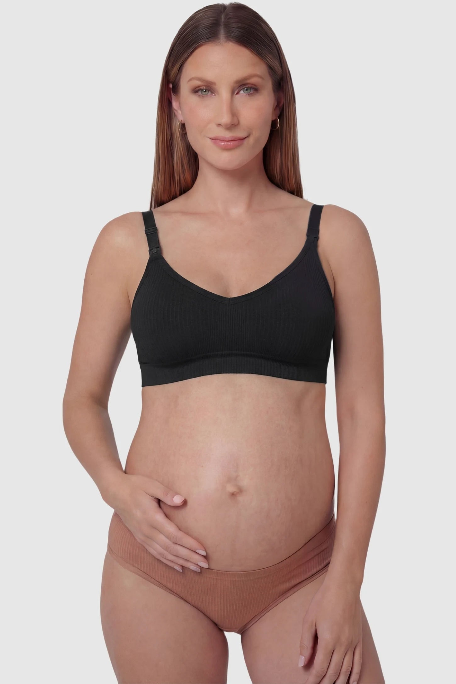 Ribbed Wireless Adjustable Shoulder Strap Nursing Bra Ribbed wireless adjustable strap nursing bra in black with front clasp, front view on pregnant model